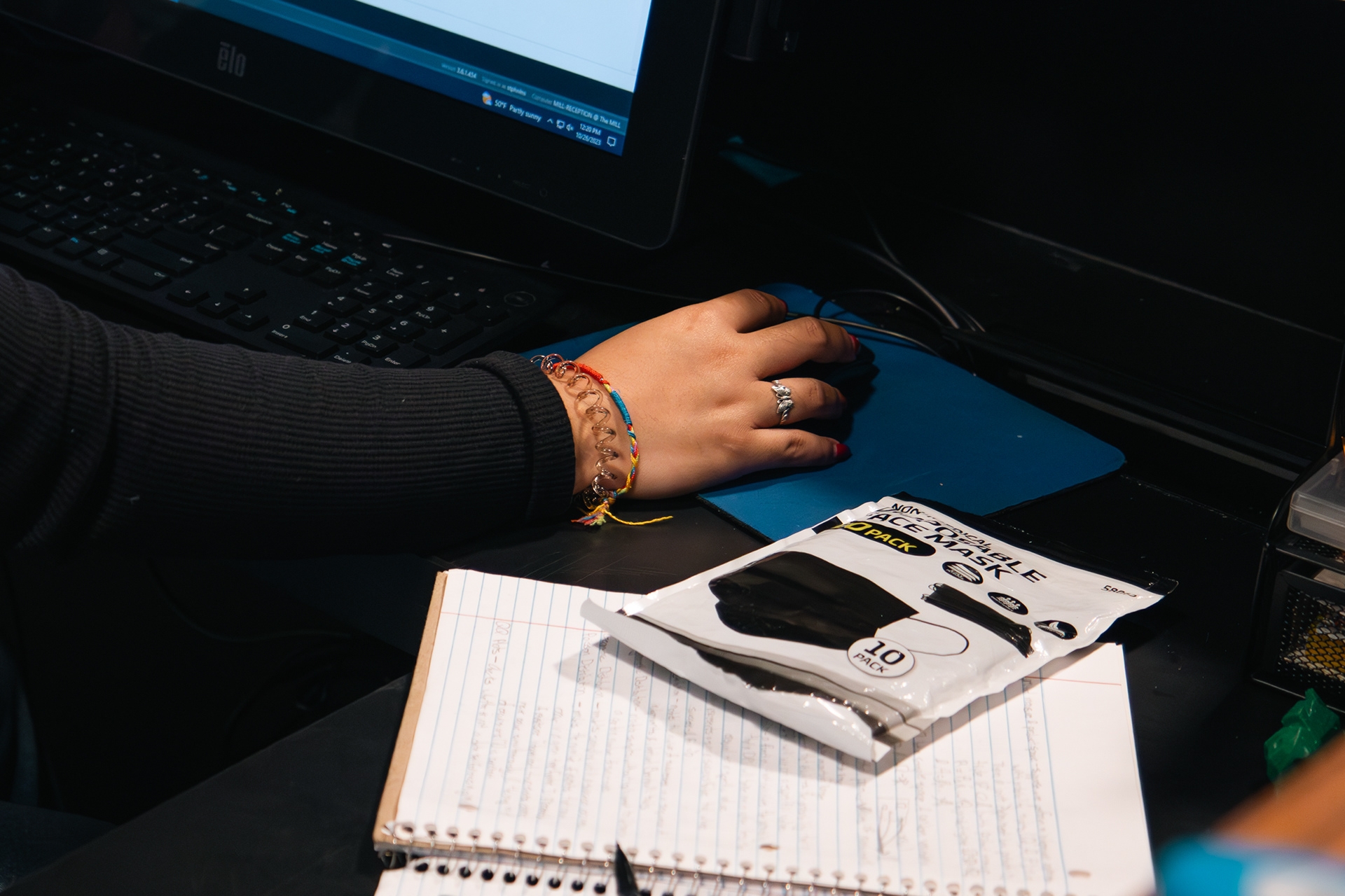 A pack of masks is pictured behind the desk at The Mill on Thursday, Oct. 26, 2023. Giron keeps masks on hand in case students at The Mill need one. (Photo by Chloe Sarmiento) 