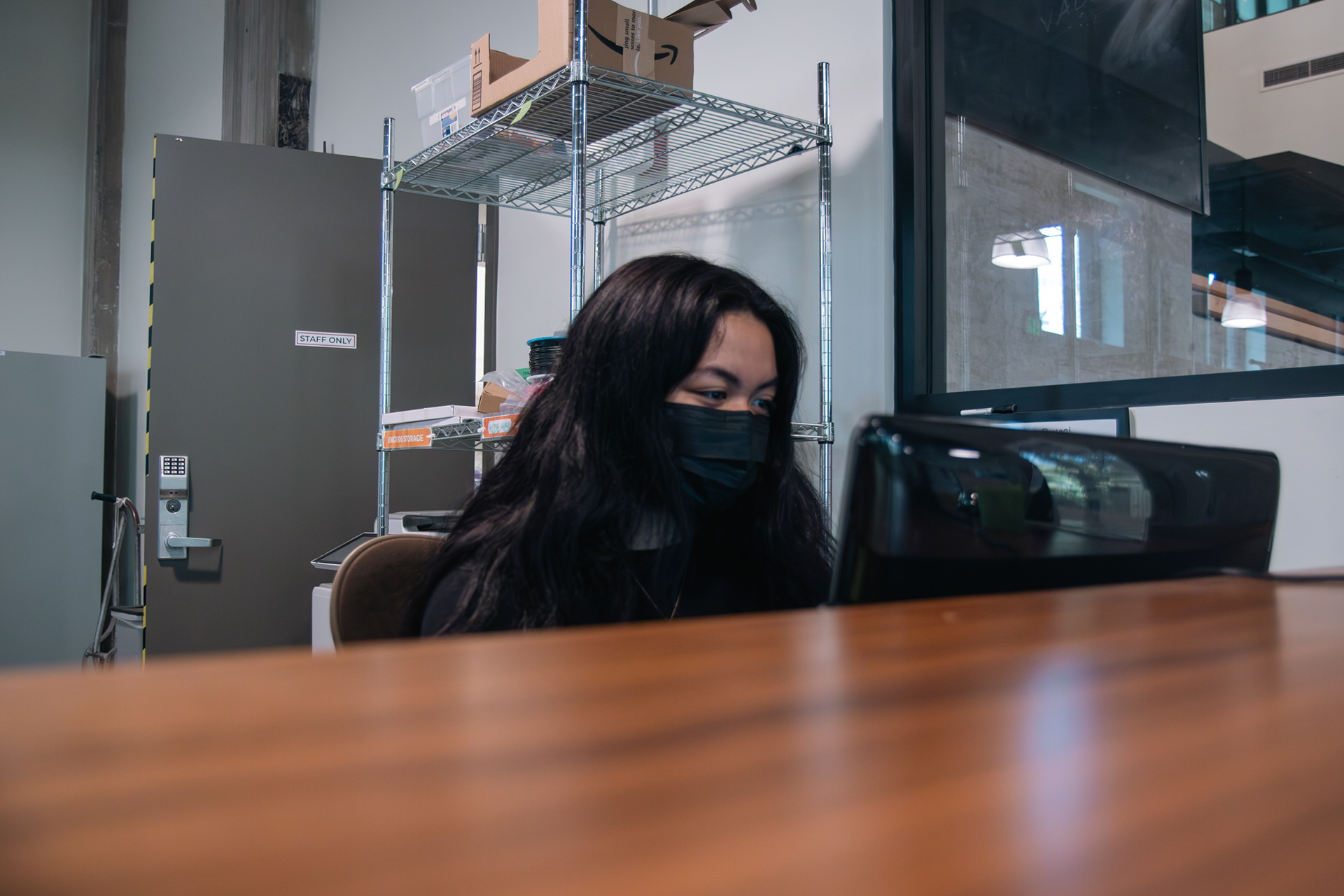 Isabella Giron, 20, is seen wearing a mask as she works at The Mill at the University of Washington in Seattle, Wash. on Thursday, Oct. 26, 2023. Giron consistently wears a mask because she frequently visits her high-risk father and wants to ensure that she doesn't spread any illness. (Photo by Chloe Sarmiento)