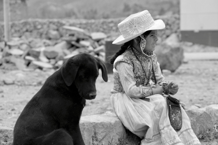 Girl with black dog (Colca Canyon region, Peru)