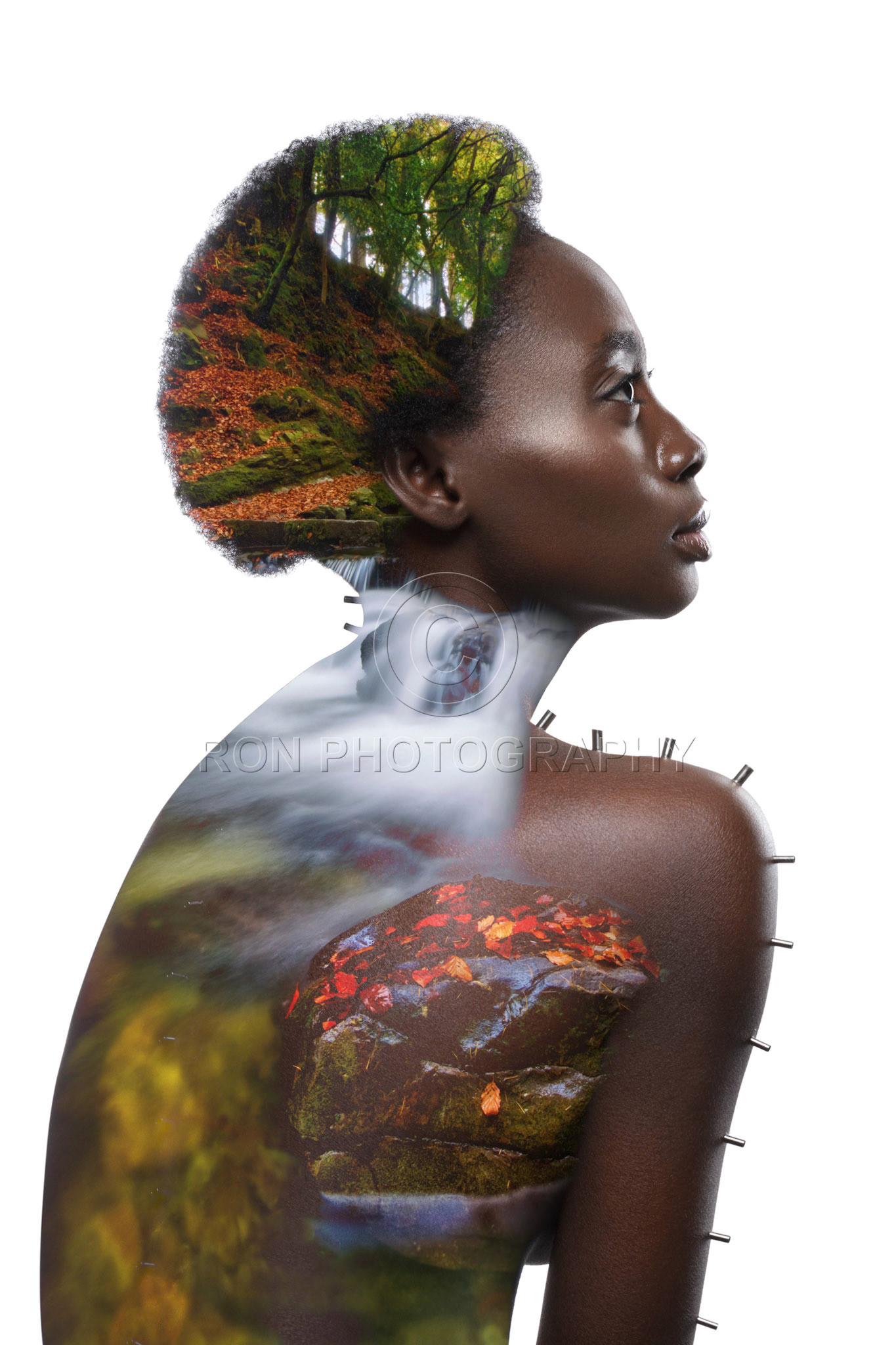 Beautiful naked young black woman with metal pins on body. Profile isolated on white background. Copy space.