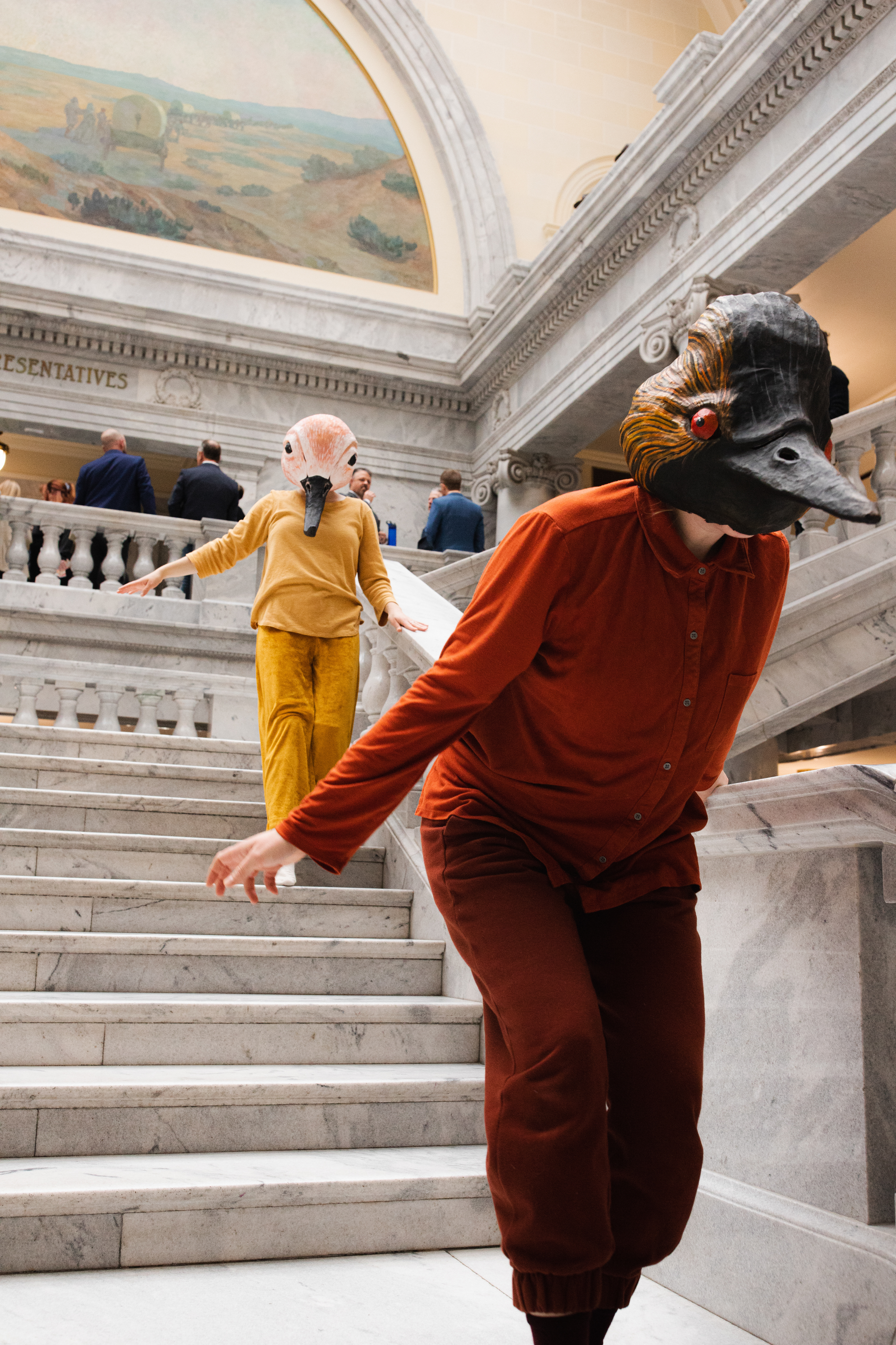 Sarah moves as Grebe in a piece performed at Utah's 2024 legislative session. Collaborators are Rae Luebbert and Bryn Watkins. Photo by Ash Gerlach. Masks by String and Shadow.