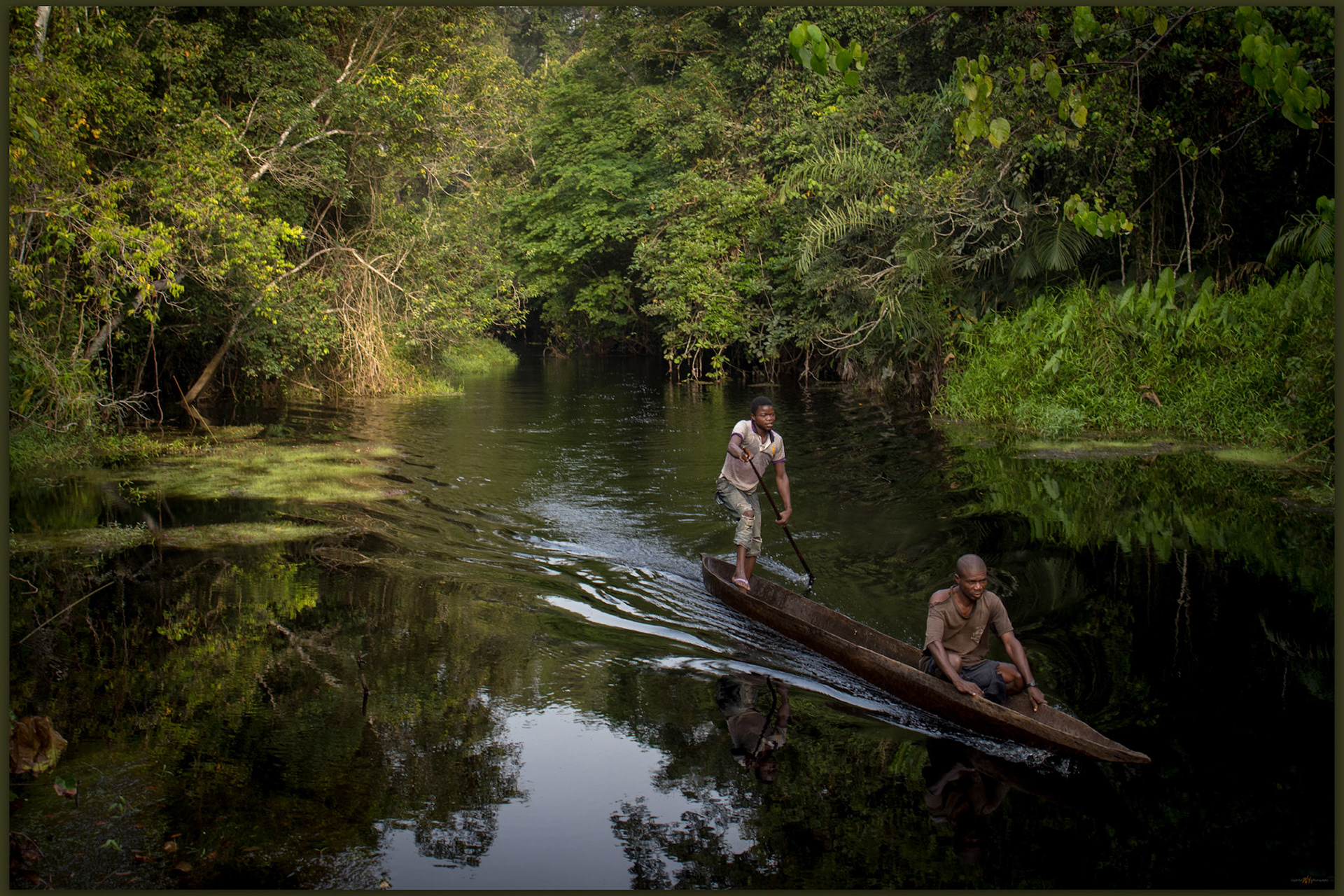 Armand and Samplese arrive in our common transport on the tributaries of the Lobaye, Moluku Region, Central African Republic