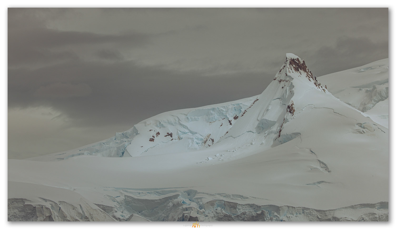 Jags. Patches of light beneath the clouds of the Antartic Peninsula