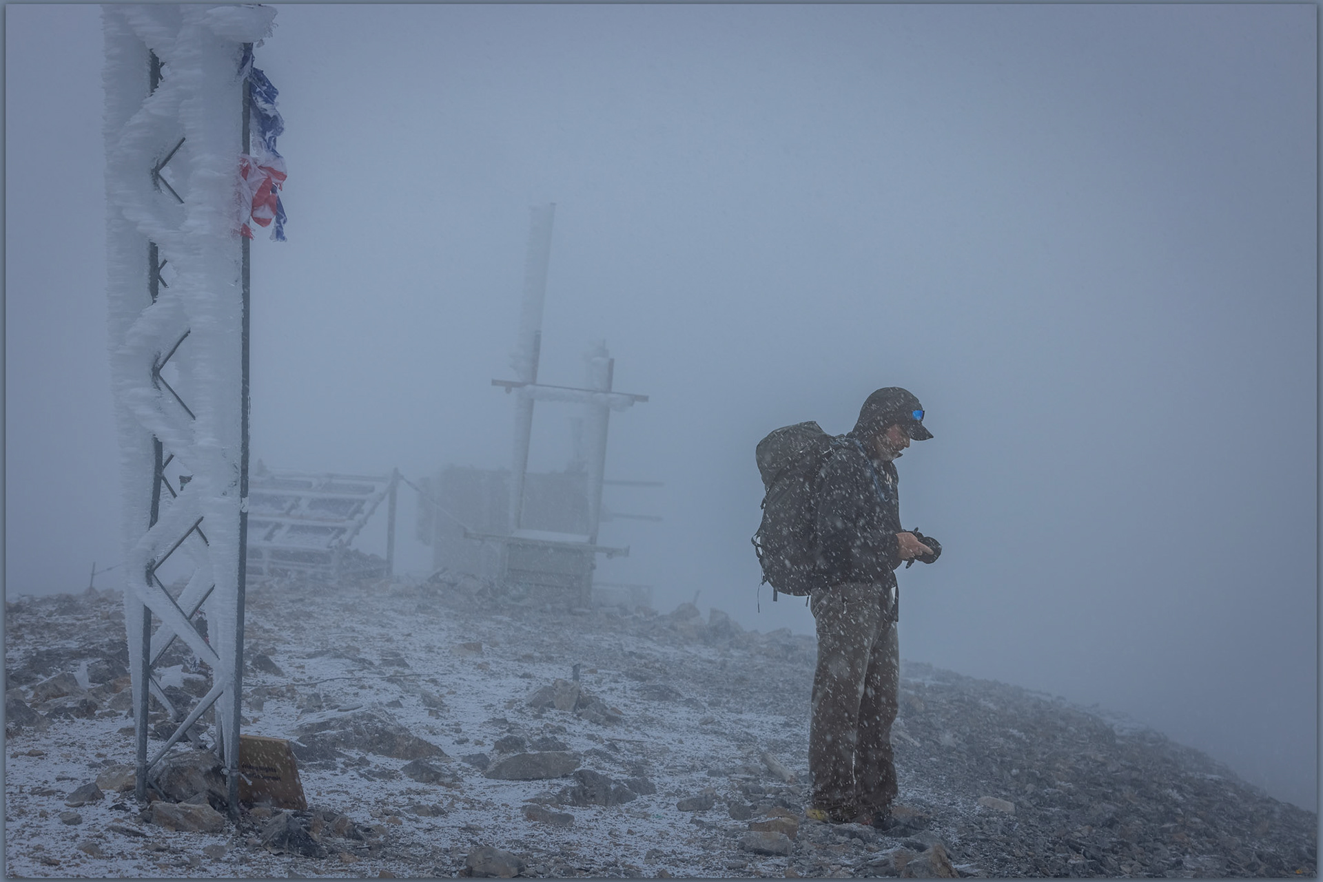Darren checks the weather on the summit of Charleston Peak, Spring Mountains, Mojave Desert, USA
