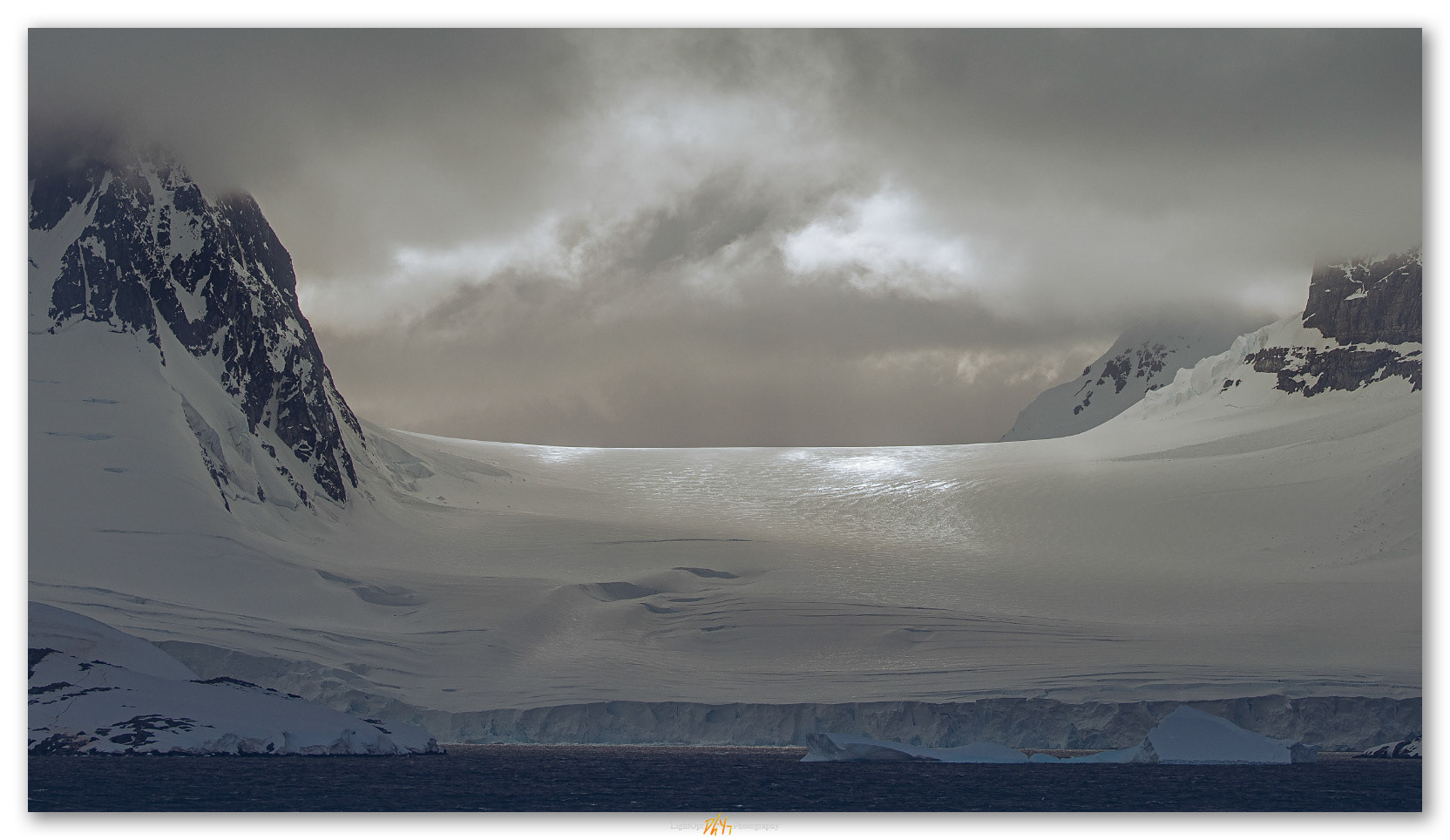 Pass light. Approach storm on a glacial front along the coast of Antarctica
