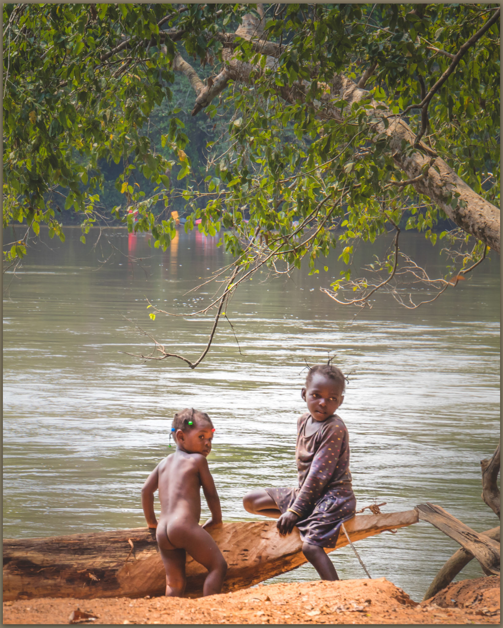 Girls play shyly at the river crossing, Central African Republic