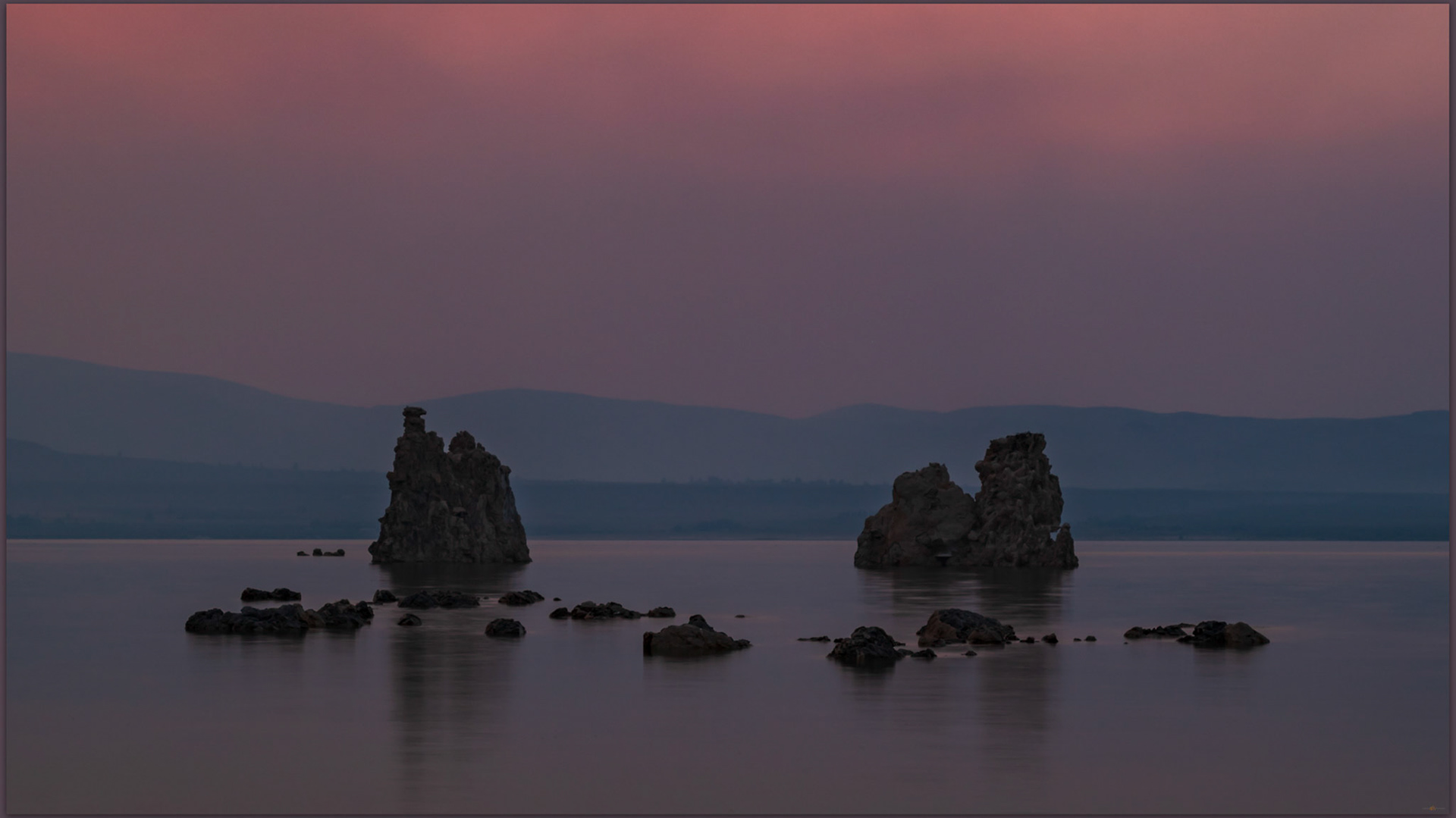 Tufa and smoke. A long exposure as early darkness set the mood at Mono Lake Tufa State Nature Reserve, Eastern Sierra, CA, USA