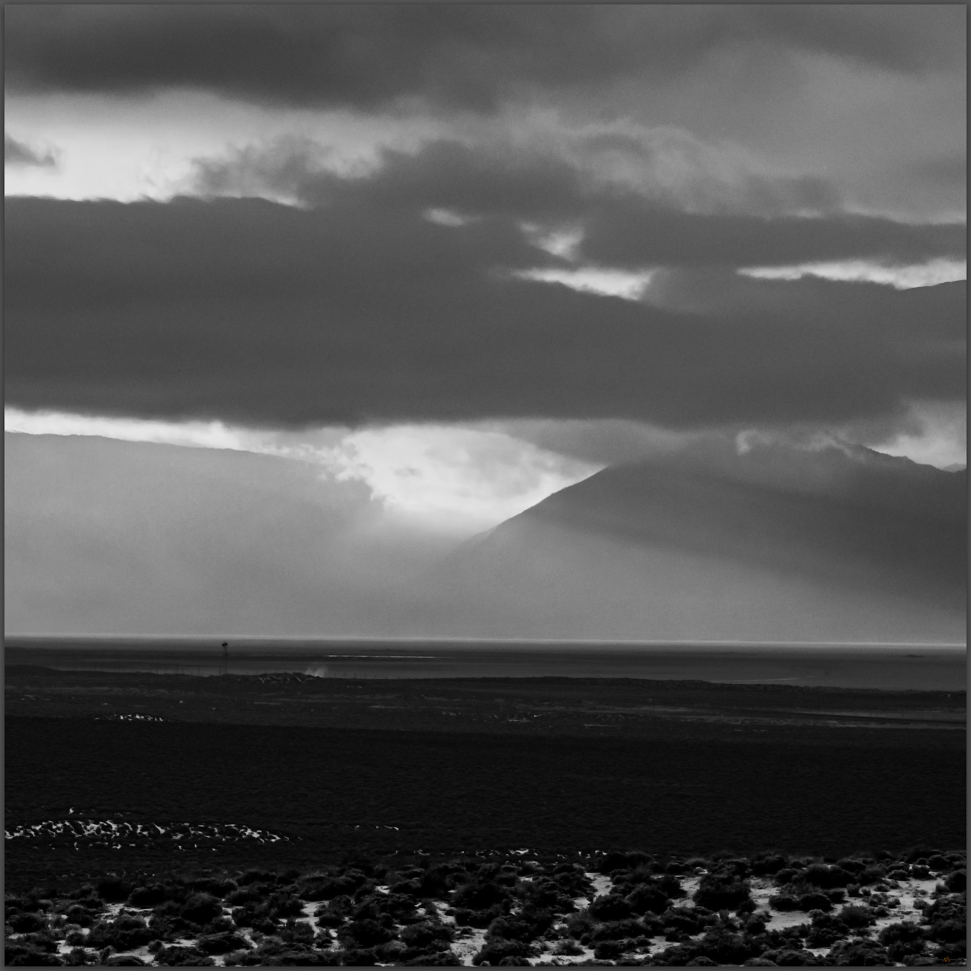 An experiment in black and white -- I am happy with the compressed view of the sunset and the break in the Granite Range, the steam of hot springs rise in the mid-ground, Black Rock Desert, Great Basin Desert, Nevada, USA