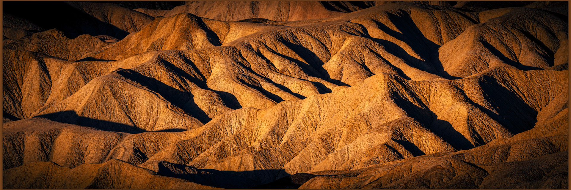 Surface lands. The golden light and cool contrast absorb me, Death Valley National Park, CA, USA