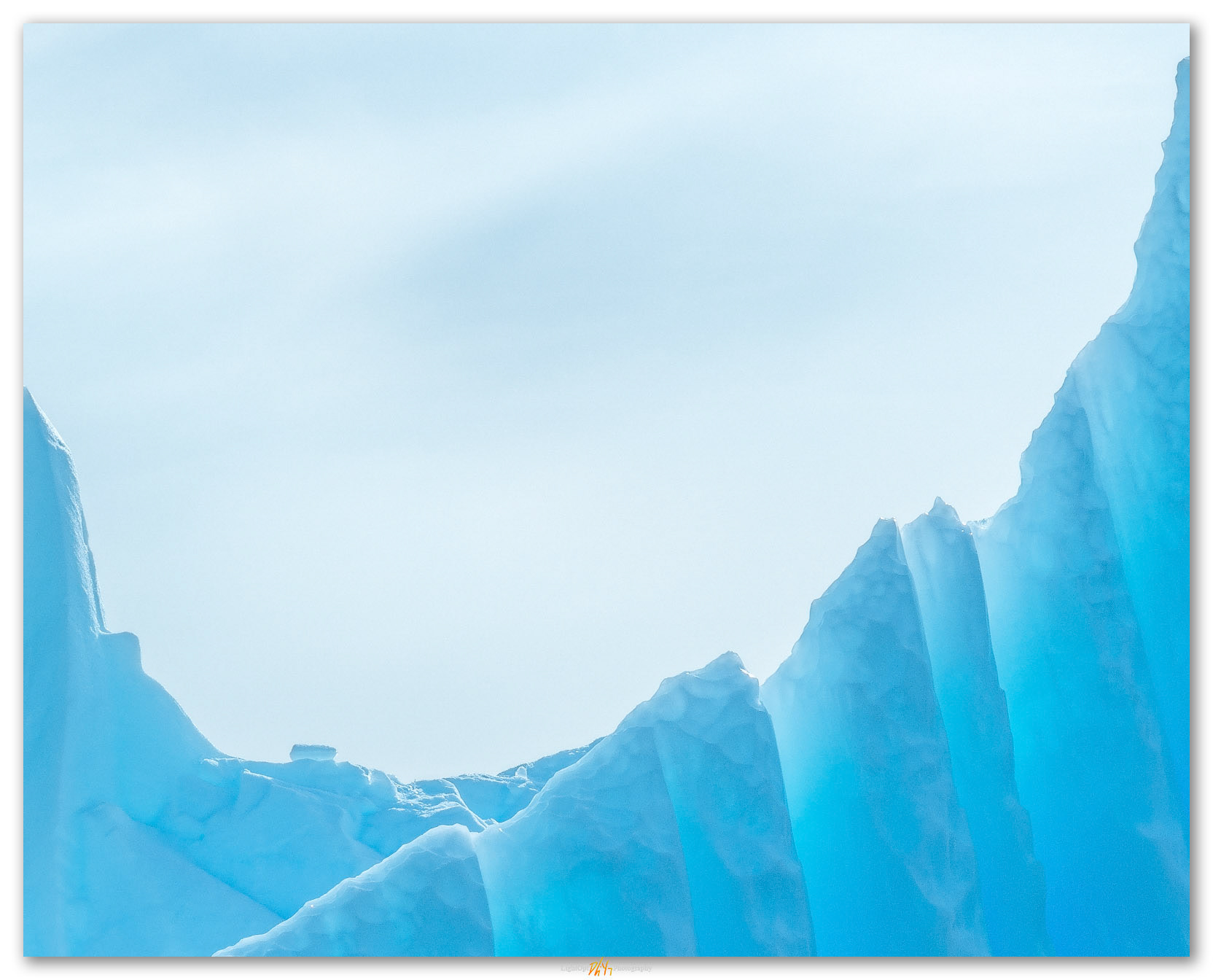 Serrate. Ice flutes on a small berg of the Antartica coast.
