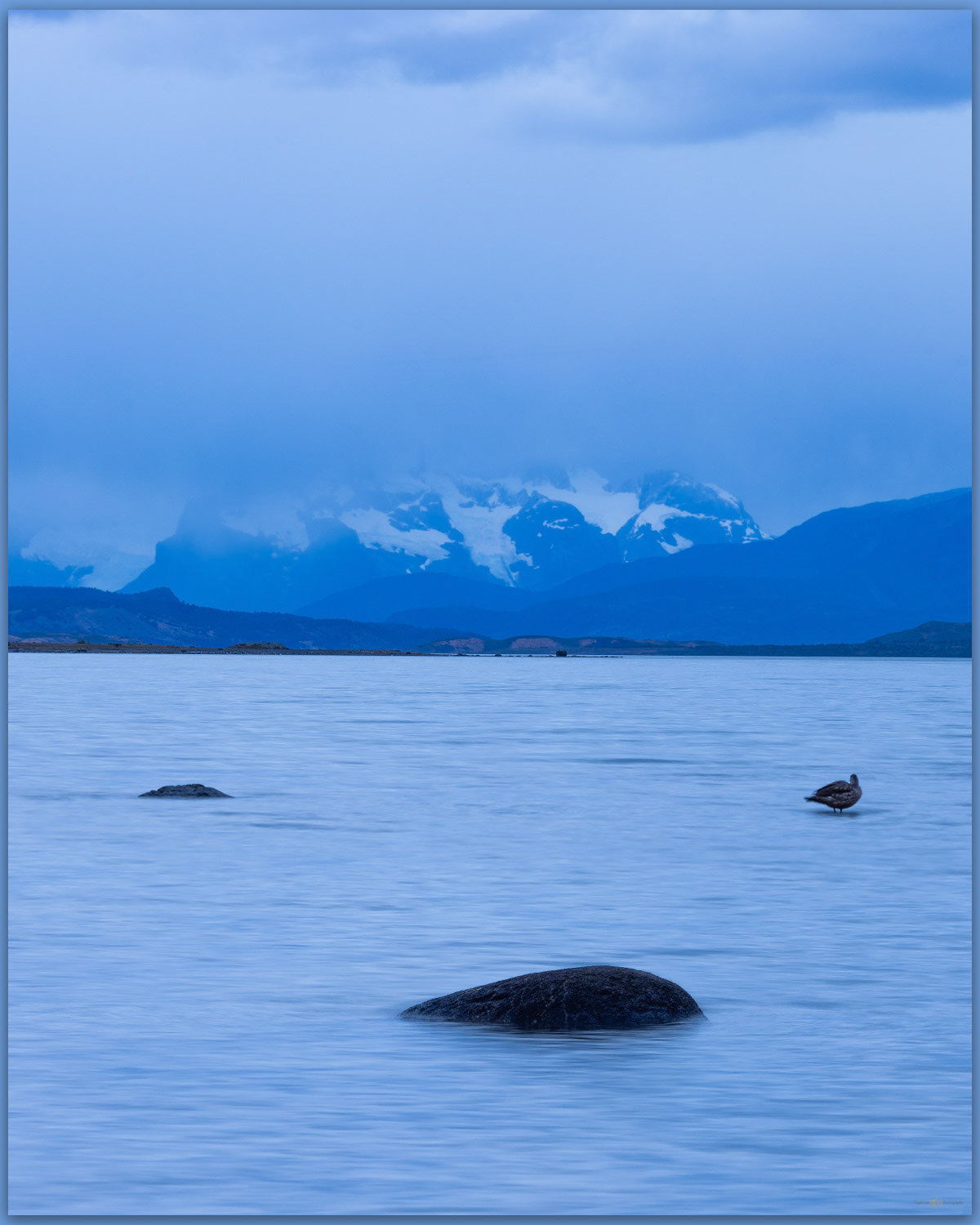 First glance. Paine Grande rises beyond the bay of Puerto Natales, Patagonia, Chile
