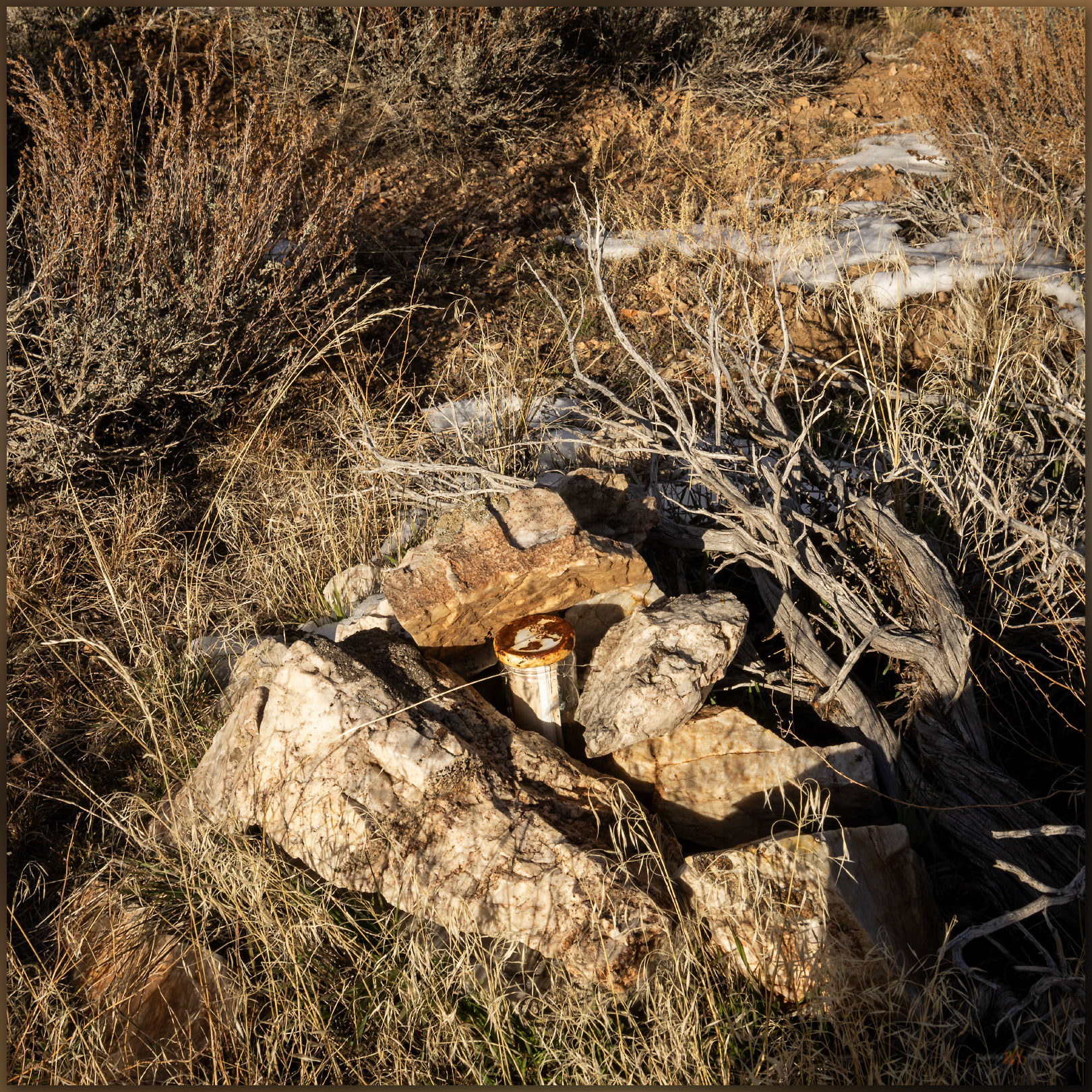 Mountain Boy register. The summit register rests in a low cairn marking the broad high point of the Mountain Boy Range, Great Basin Desert, NV, USA