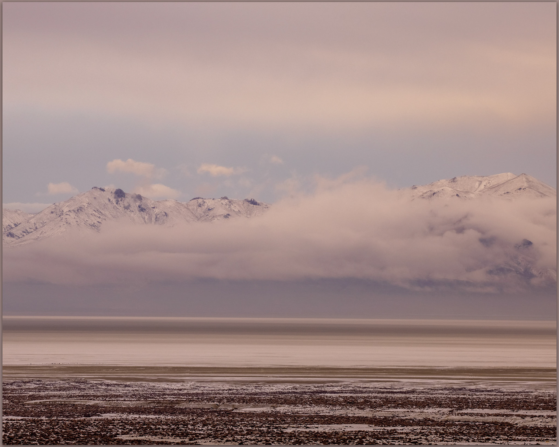 The playa in an atypical blanket of white below the breaking storm, Black Rock Desert, Great Basin Desert, Nevada, USA