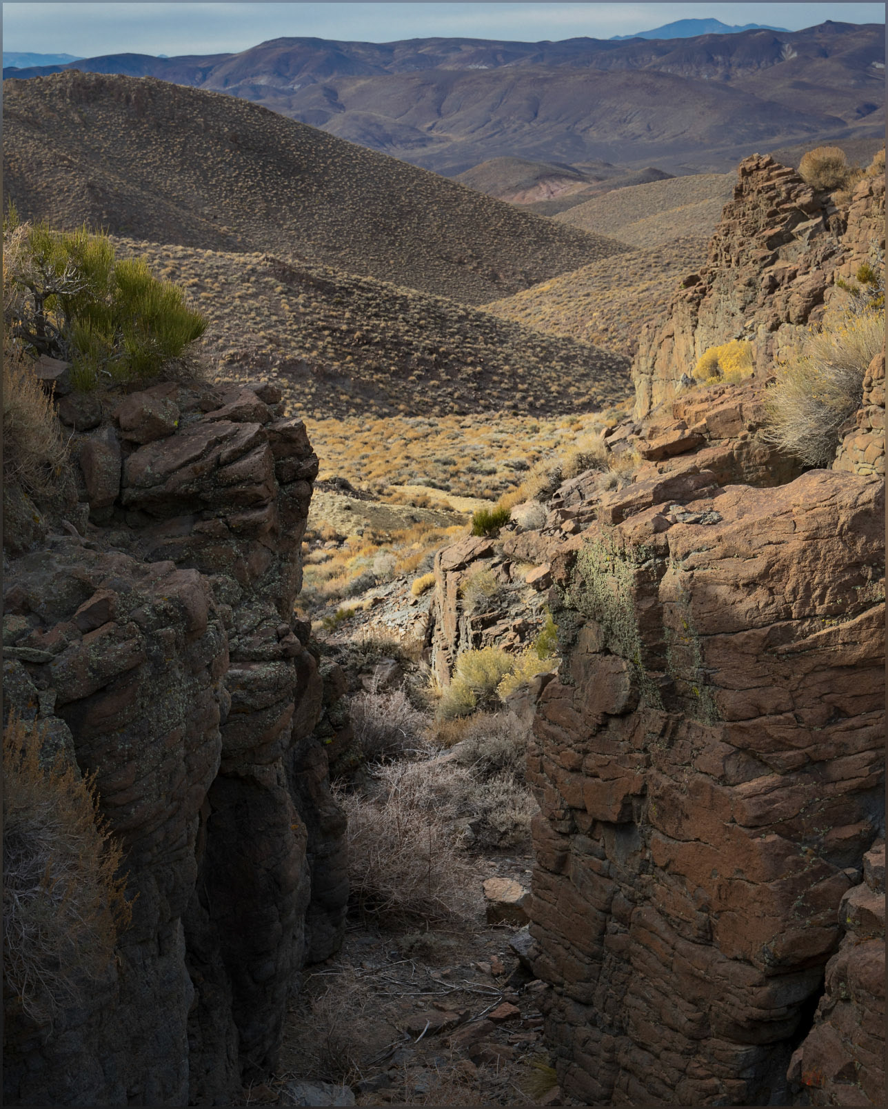 Gates. Drainages originate in steep steps of welded tuffs below the summit of the Monte Cristo Range, Great Basin Desert, NV, USA