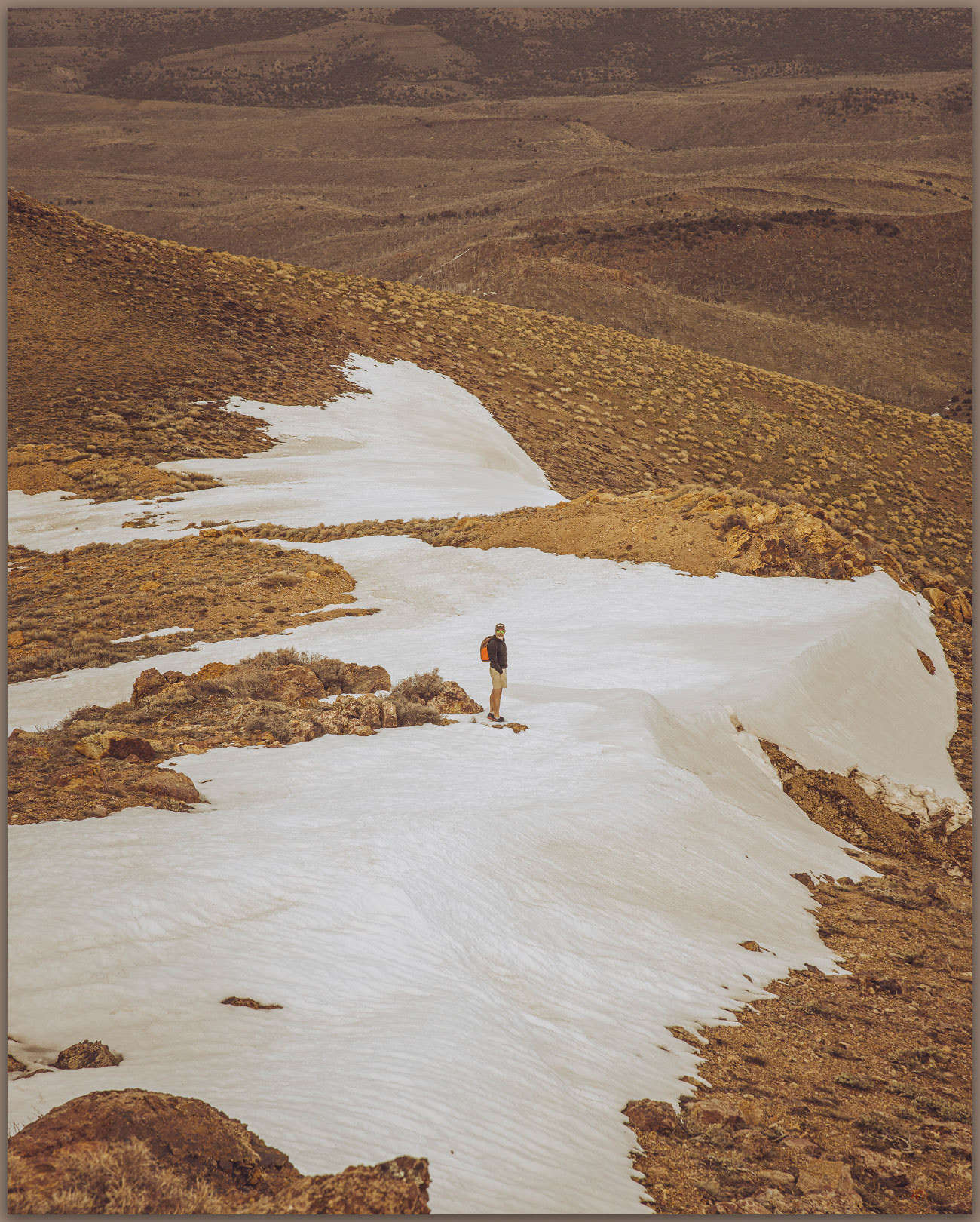 Snow patches. Darren exploring the descent from New Pass Peak, New Pass Range, Great Basin Desert, Nevada