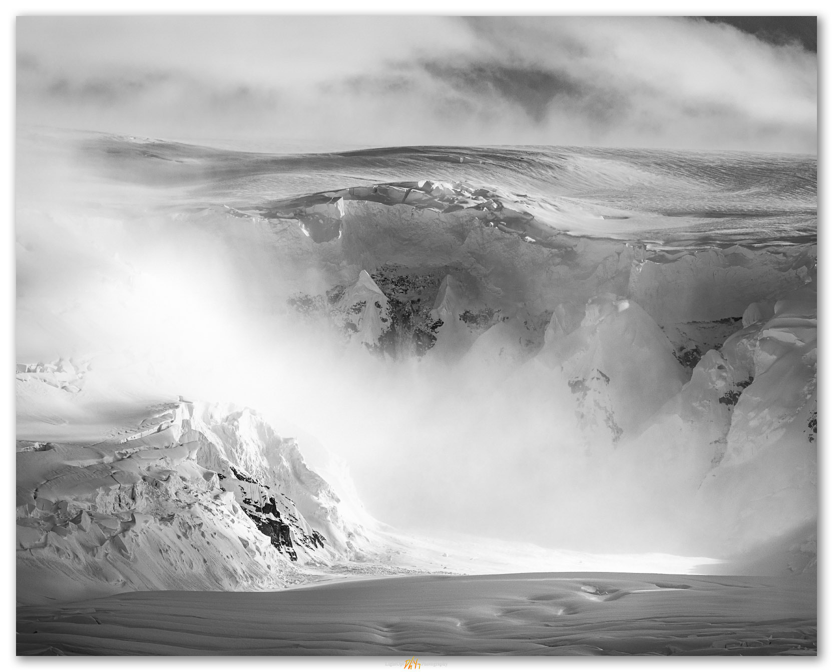 Falling light. Clouds and snow swirl in alcoves of Neko Harbor, Antarctic Peninsula
