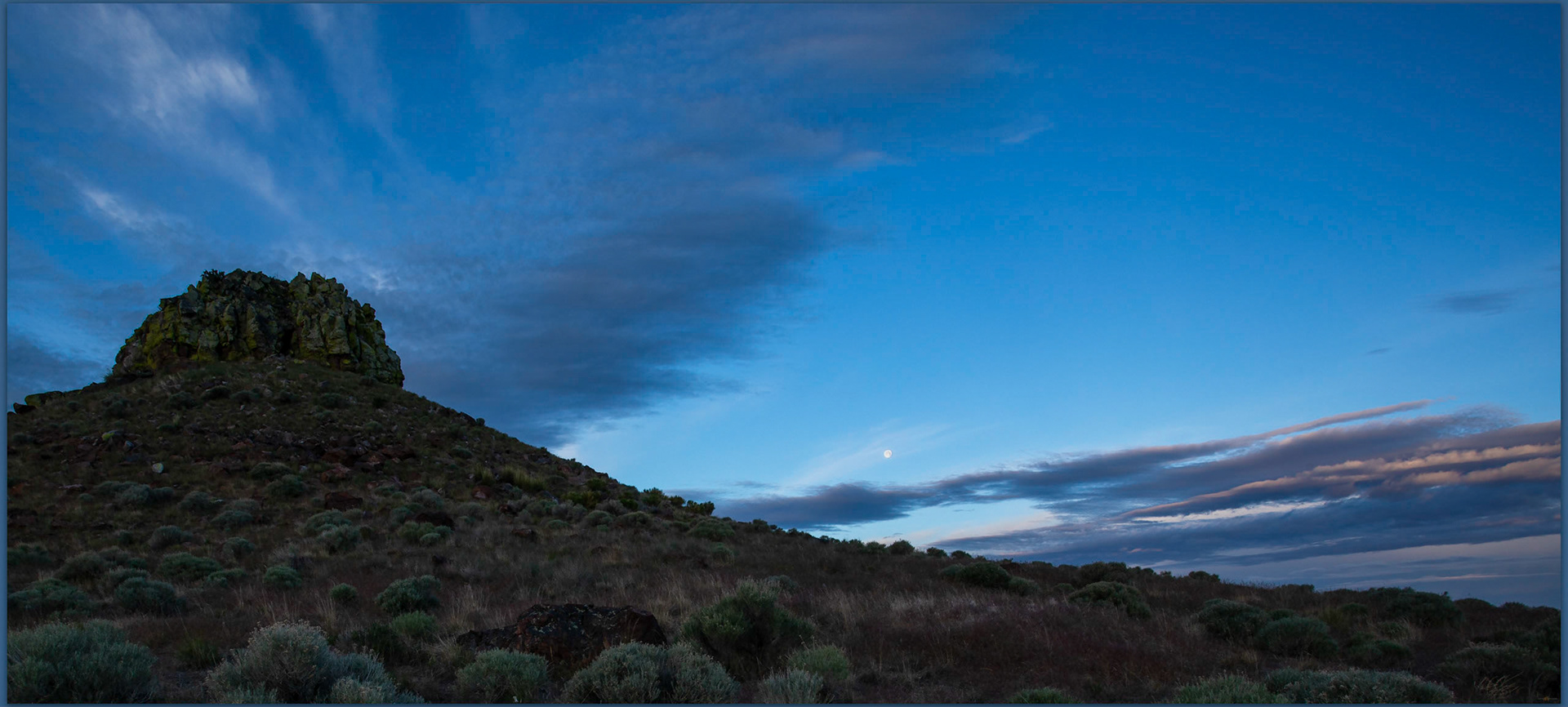 Sentinel moonset. Blue hours skies beyond Sentinel Rock, Quinn River Valley, NV, USA