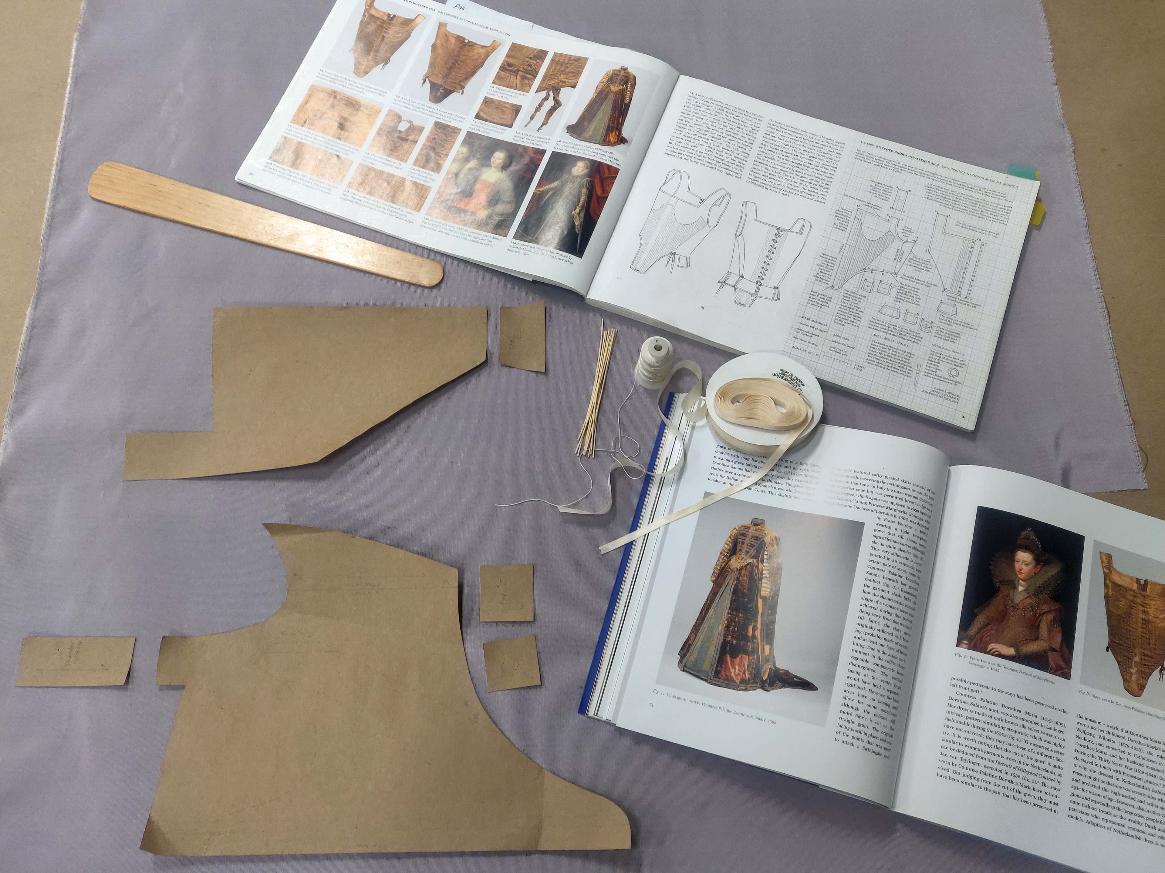 This project is a reproduction of the 1598 pair of bodies pattern out of Janet Arnold's Patterns of Fashion 5. Everything was done by hand. Ribbed silk fashion fabric, plain weave linen linning, reed boning, flattened metal jump rings for eyelet reinforcement, 2 ply silk thread, plain weave silk binging, satin weave silk ribbon for lacing, wooden busk