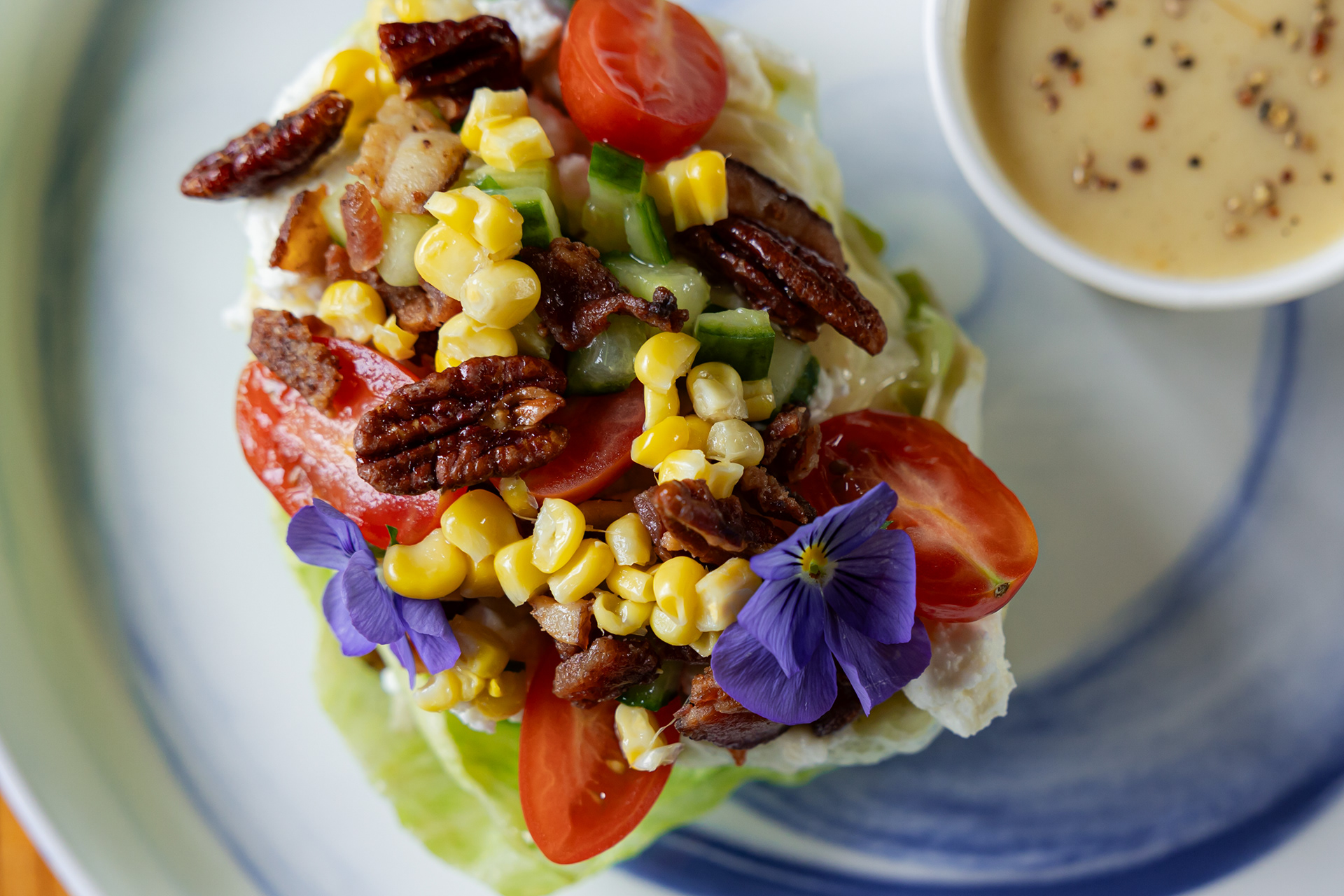 wedge salad with corn, pecans, tomato, bacon, and flowers from The Depot Auburn AL