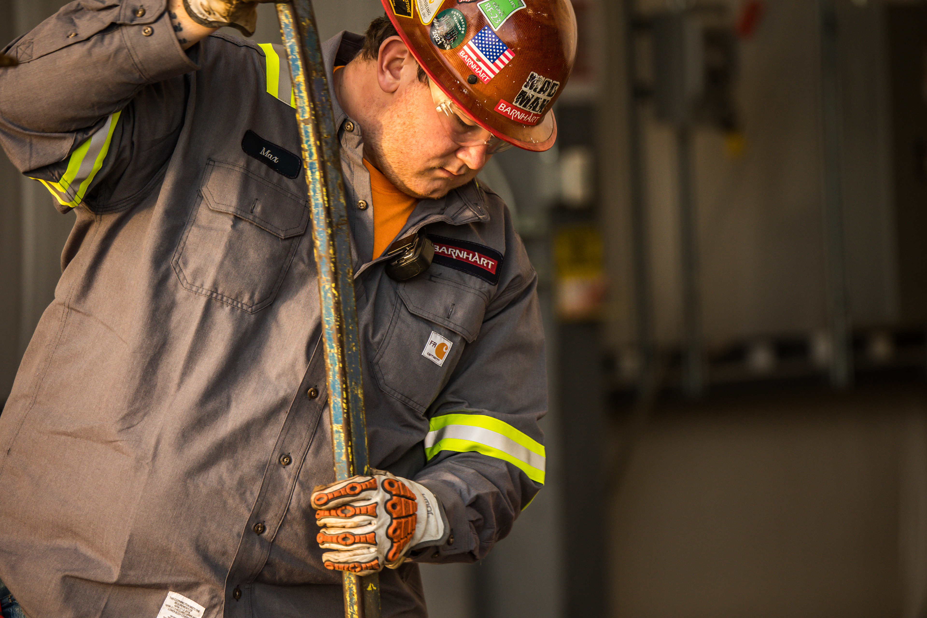 a medium shot of a Barnhart construction worker in safety gear and a metal stake