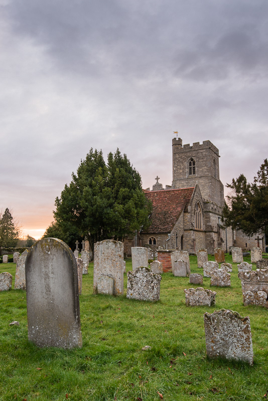 The sun setting behind St Owens church in Bromham, Bedfordshire.