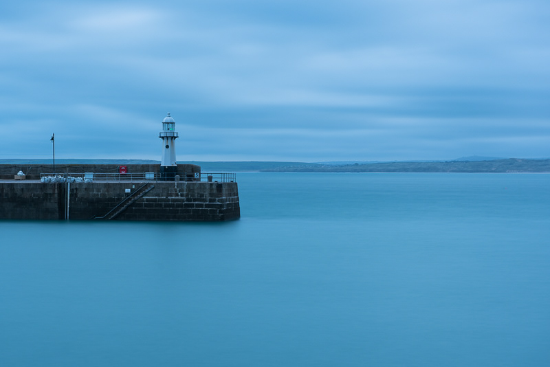 Smeaton's Pier at St Ives harbour, Cornwall in the early morning blue hour before sunrise.