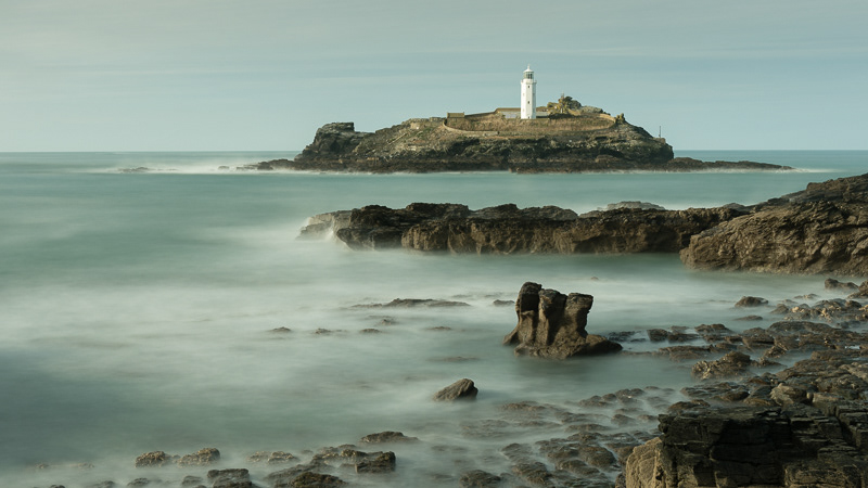 Grodrevy Island Lighthouse, Cornwall on a calm afternoon.