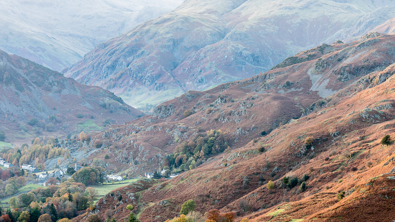 Interlocking fells above Elterwater viewed from Loughrigg Fell in the Lake District.