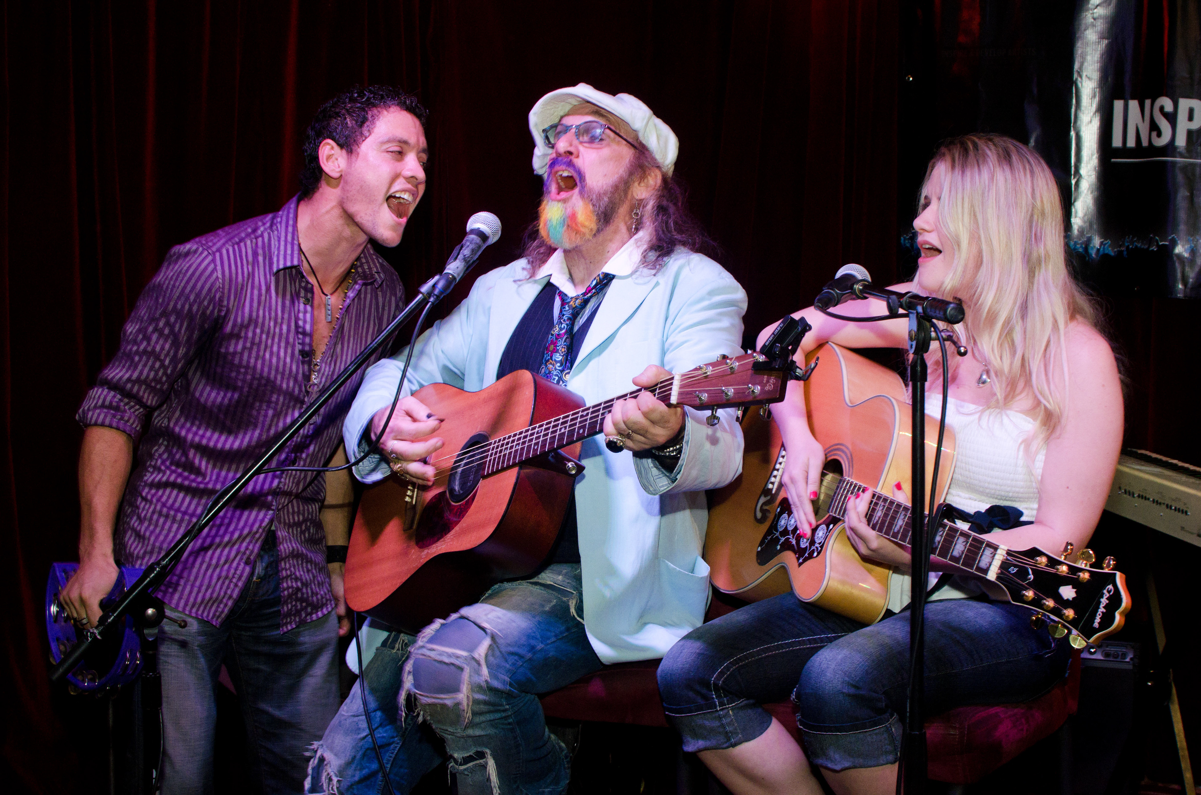 Image taken by Monika Zdziebkowska of Monika Photo Life of 3 singers. two of them singing and playing a guitars