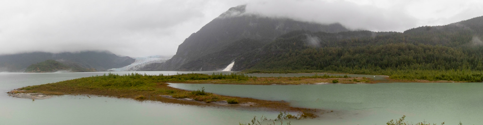 A panoramic shot of the Mendenhall Glacier and Nugget falls. The Glacier is currently about 13 miles long, but 50 years ago it filled the entire valley that is now the lake you see I front of the Glacier.