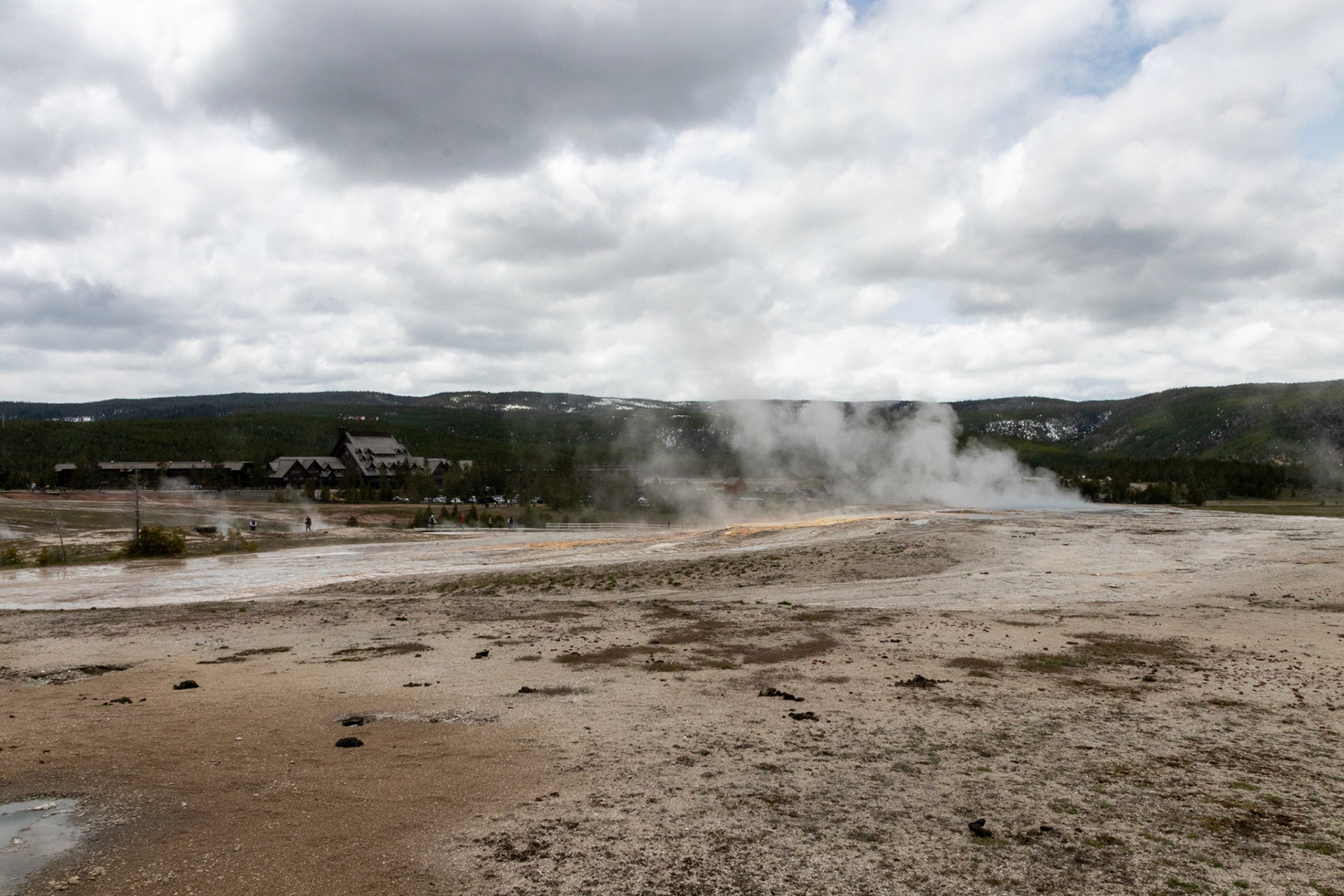 Old Faithful Lodge in the background of the Upper Geyser basin.