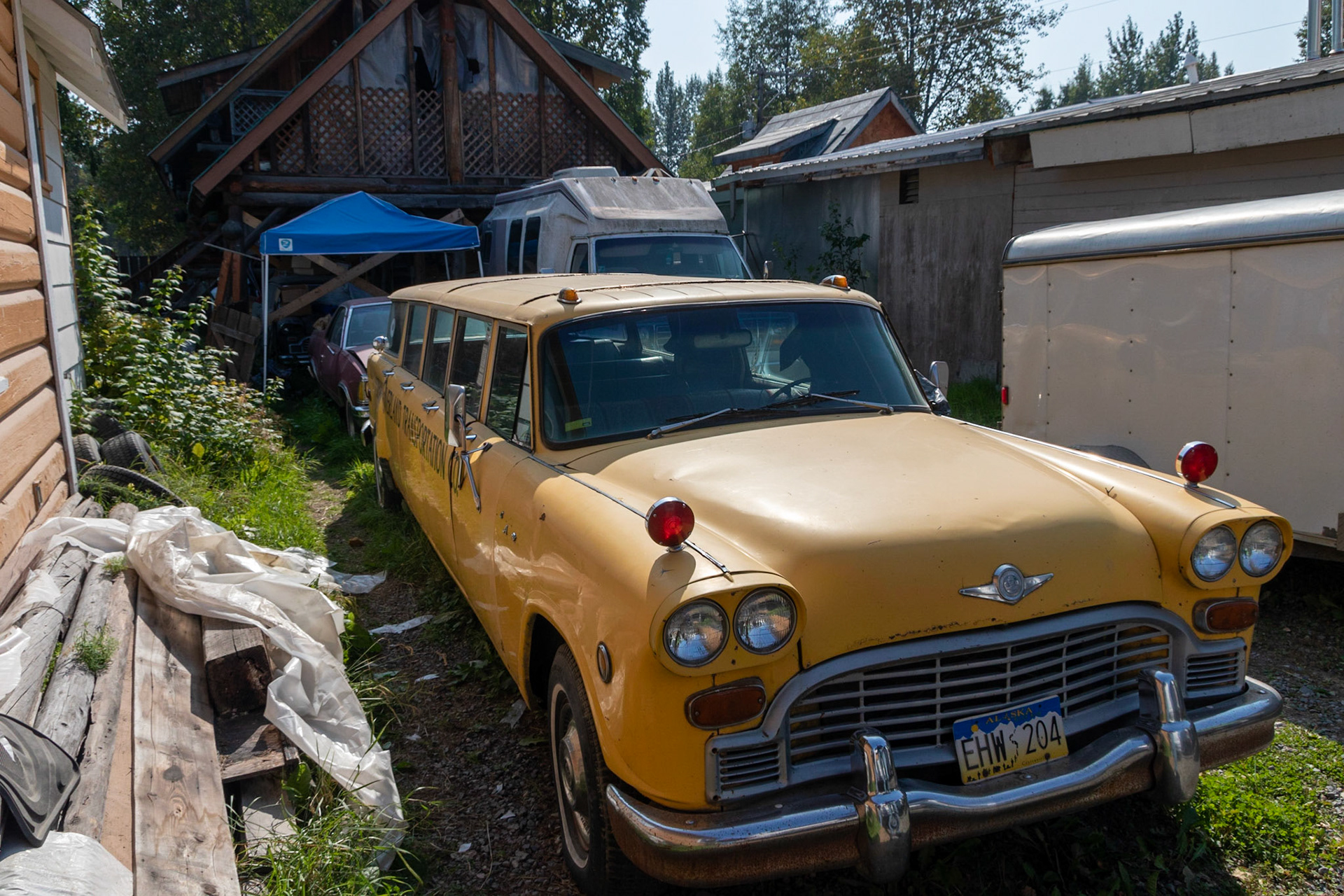 A stretched classic yellow cab. Found in dilapidated condition between two buildings along main street in Talketna.