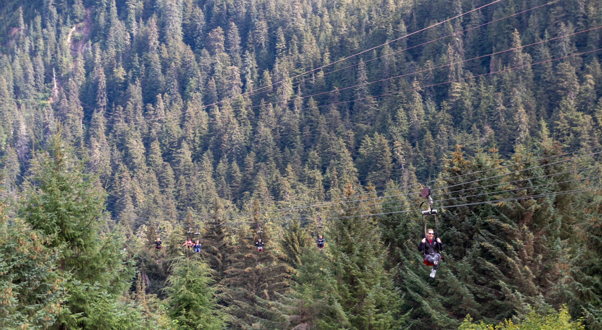 Some people riding down the ZipRider at Icy Straight Point. Icy Strait Point features the world's largest ZipRider, with six 5,330’ ziplines dropping 1330’. After launching, you will quickly accelerate to speeds exceeding 60 mph as you soar 300 feet above the rainforest below.
