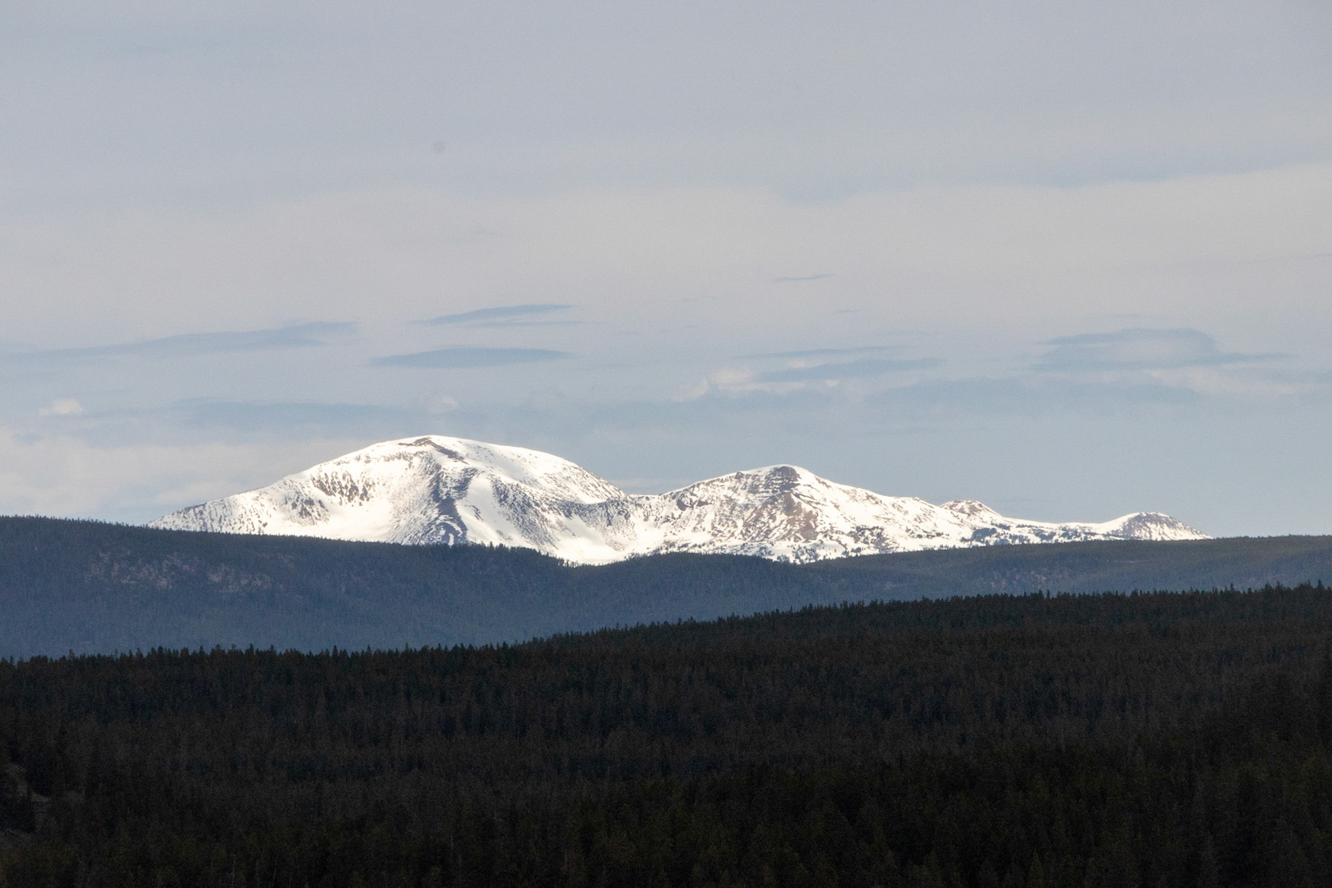 A view of the snow-capped mountains in the distance overlooking the Yellowstone Caldera