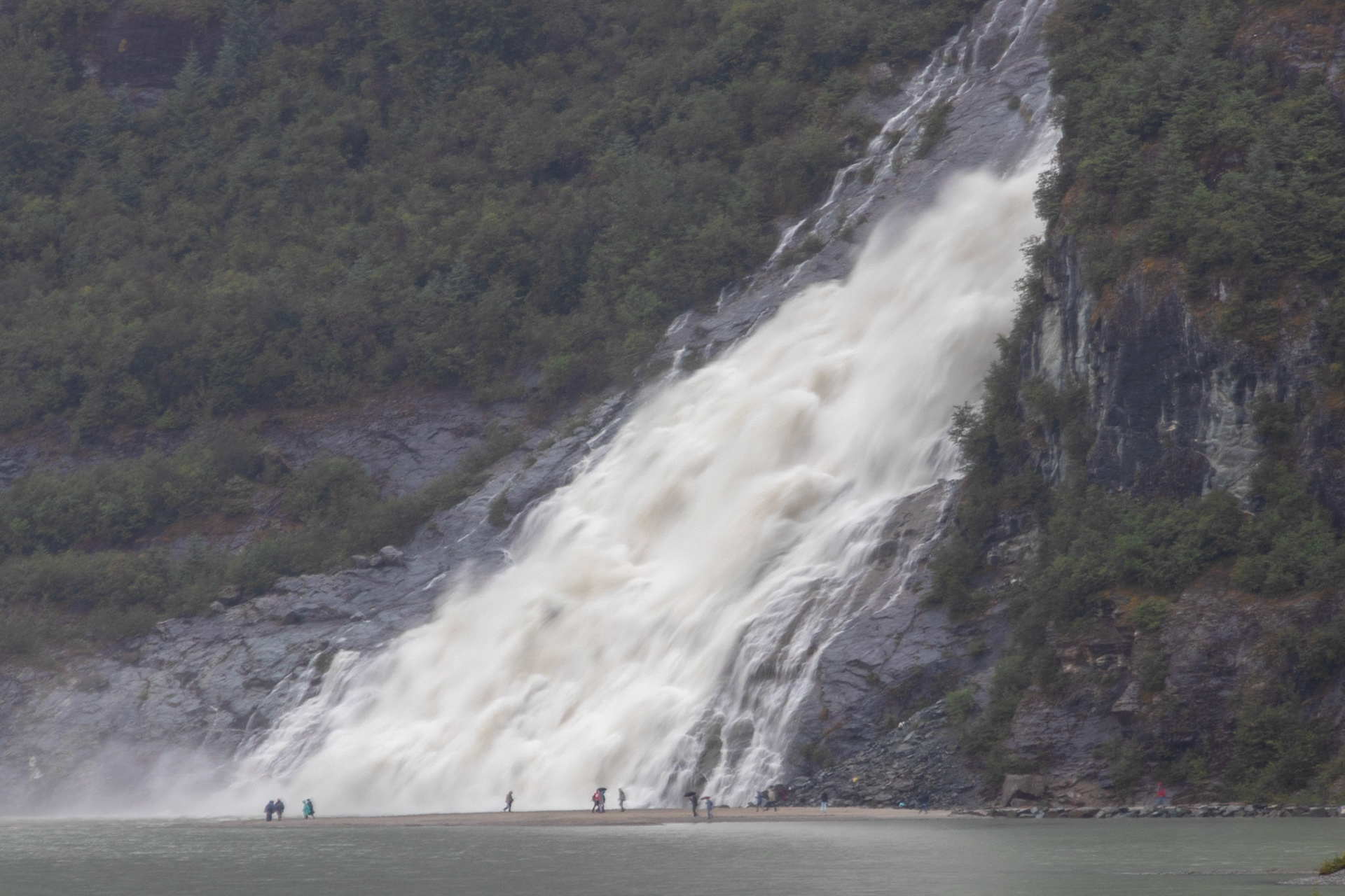 A view of Nugget Fals at the Mendenhall glacier. Note the crazy people at the base of the waterfall.