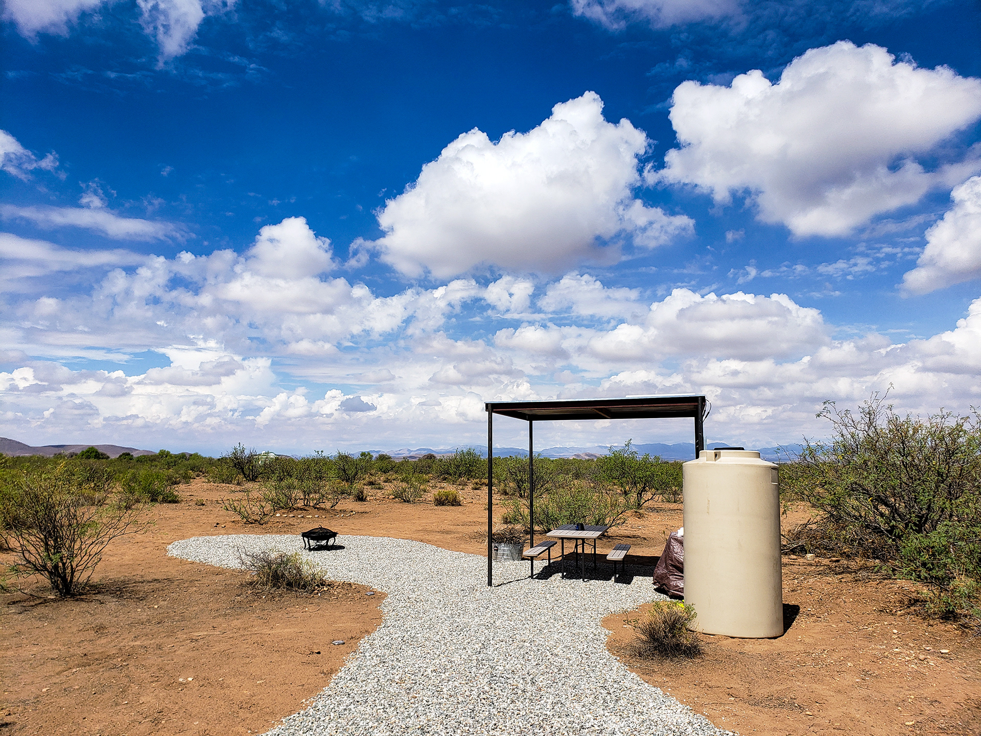 Peaks Valley Preserve campground with picnic table, fire pit, and water tank