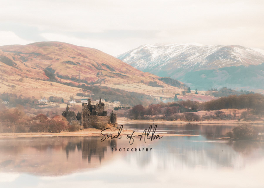 Kilchurn Castle Reflecting off Loch Awe in Argyll with beautifull snowcapped mountains in the background