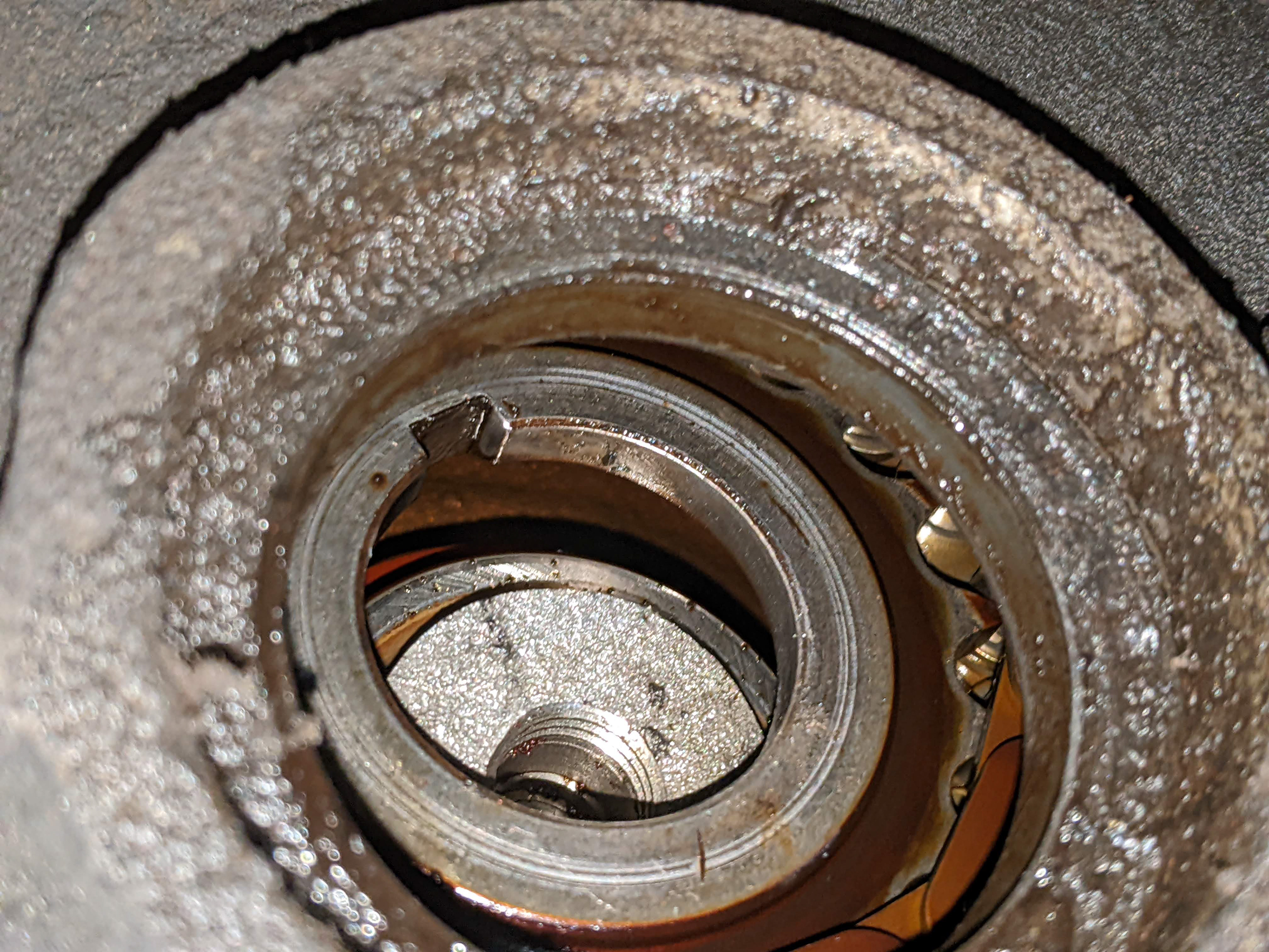 Looking through the timing chain cover at the rest of the crankshaft and the lower timing chain sprocket.