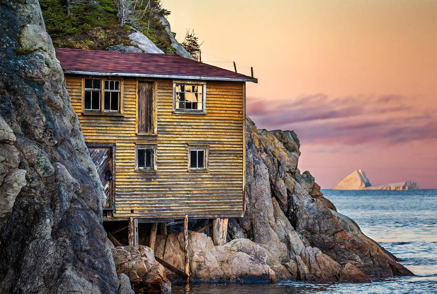 An iconic yellow house on stilts in Shoe Cove, NL