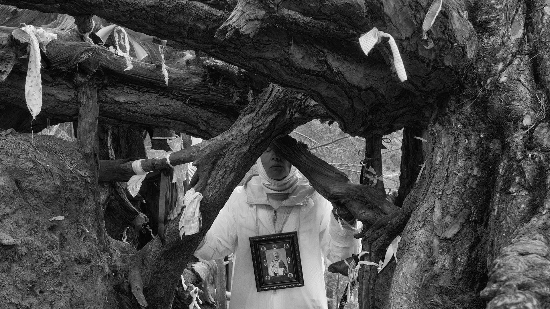 A pilgrim prays with a venerated icon of St Nicholas during the Velikoretsky procession