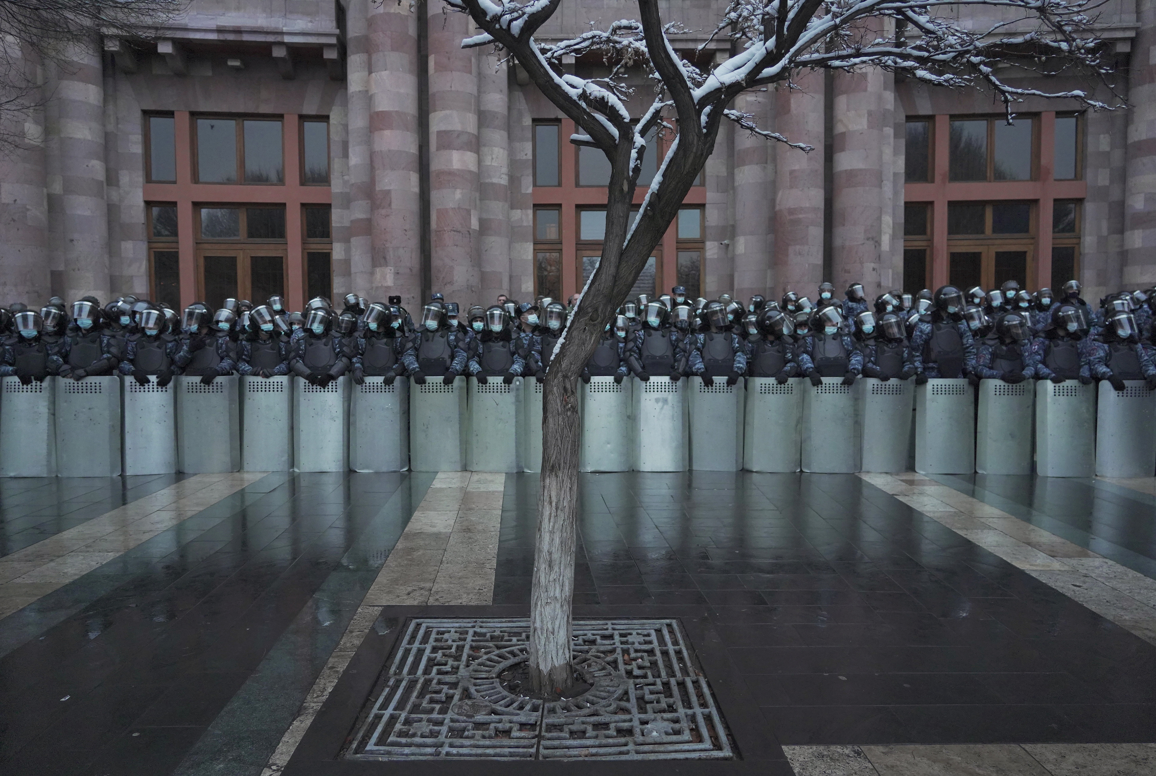 Armenian law enforcement officers stand guard outside the government office during an opposition rally to demand the resignation of Prime Minister Nikol Pashinyan in Yerevan, Armenia February 20, 2021. REUTERS/Artem Mikryukov