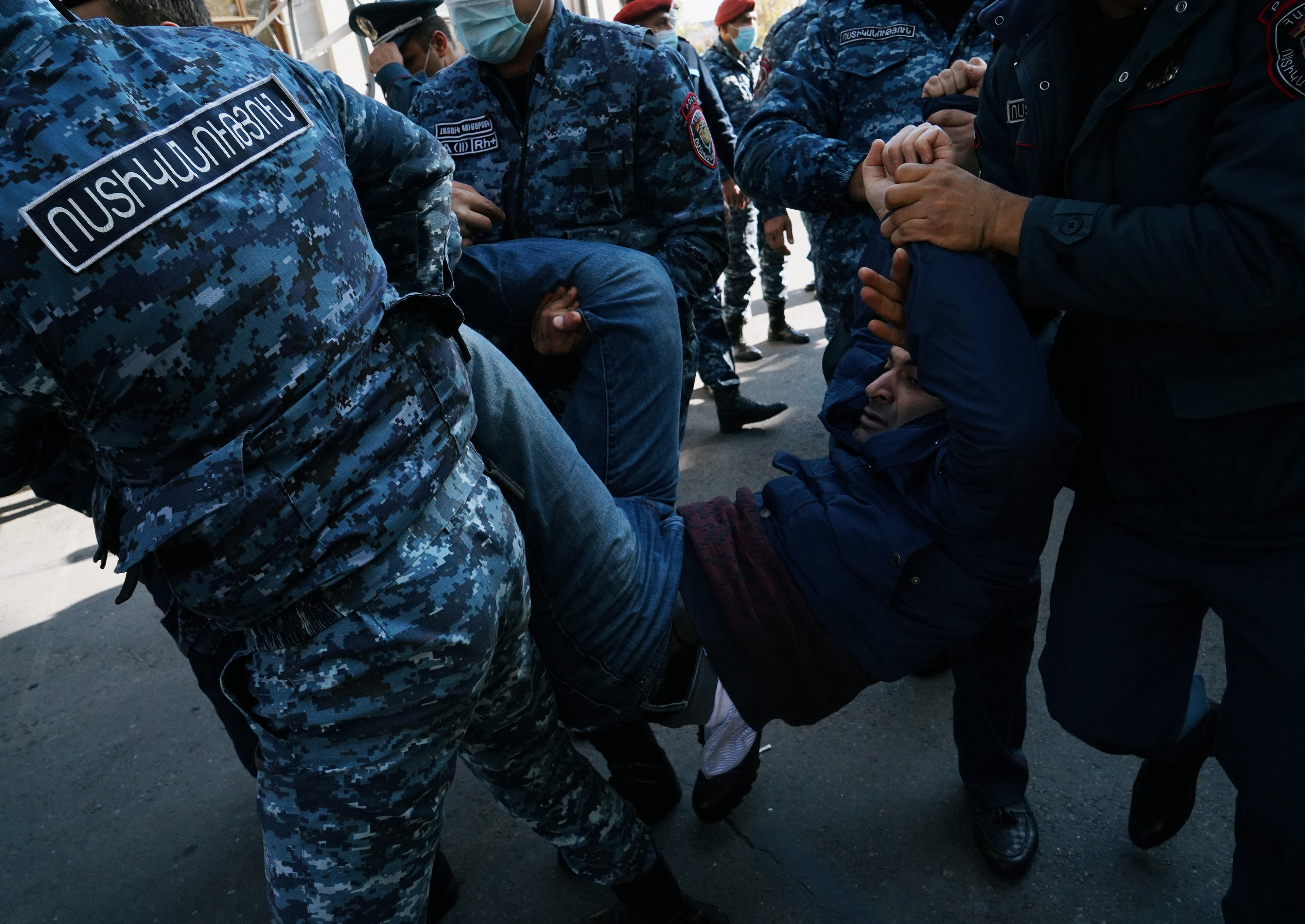 A demonstrator is taken away by law enforcement officers during an opposition rally to demand the resignation of Armenian Prime Minister Nikol Pashinyan following the signing of a deal to end the military conflict over the Nagorno-Karabakh region, in Yerevan, Armenia November 11, 2020. REUTERS/Artem Mikryukov