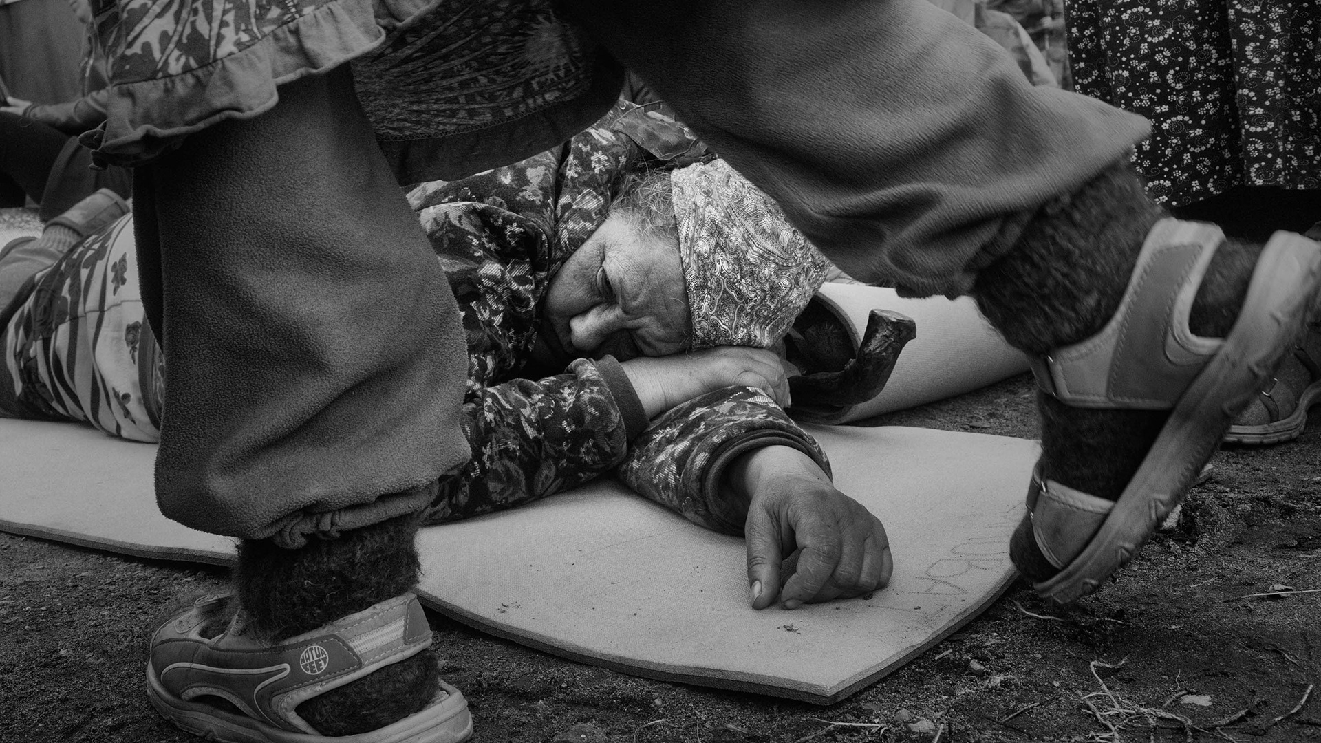 A pilgrim rests during the procession