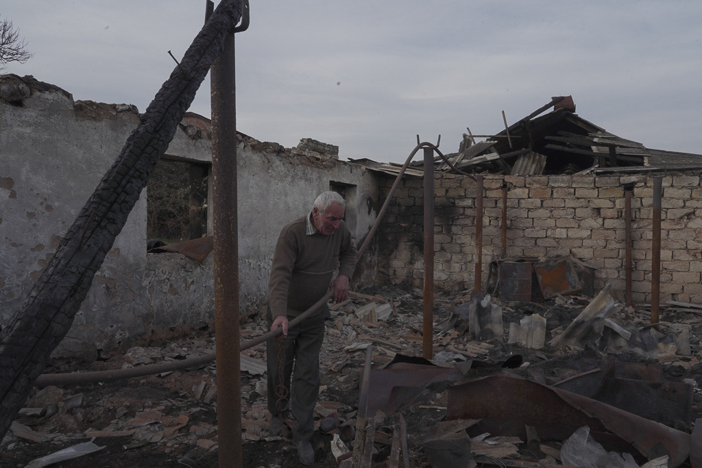 Local resident Lenser Gabrielyan, 65, stands on the ruins of his farm that was destroyed by shelling near the village of Taghavard in the region of Nagorno-Karabakh, January 16, 2021. REUTERS/Artem Mikryukov