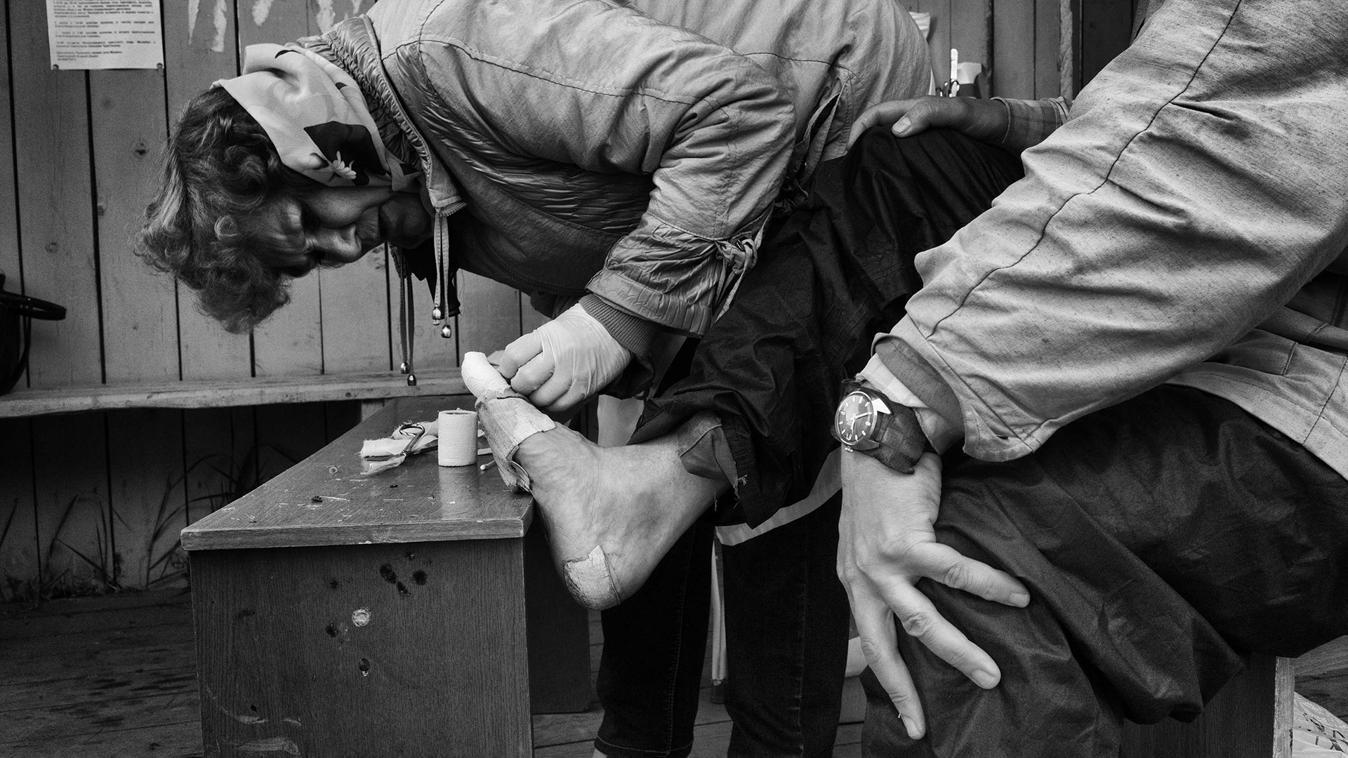 The village doctor provides first aid to the pilgrim