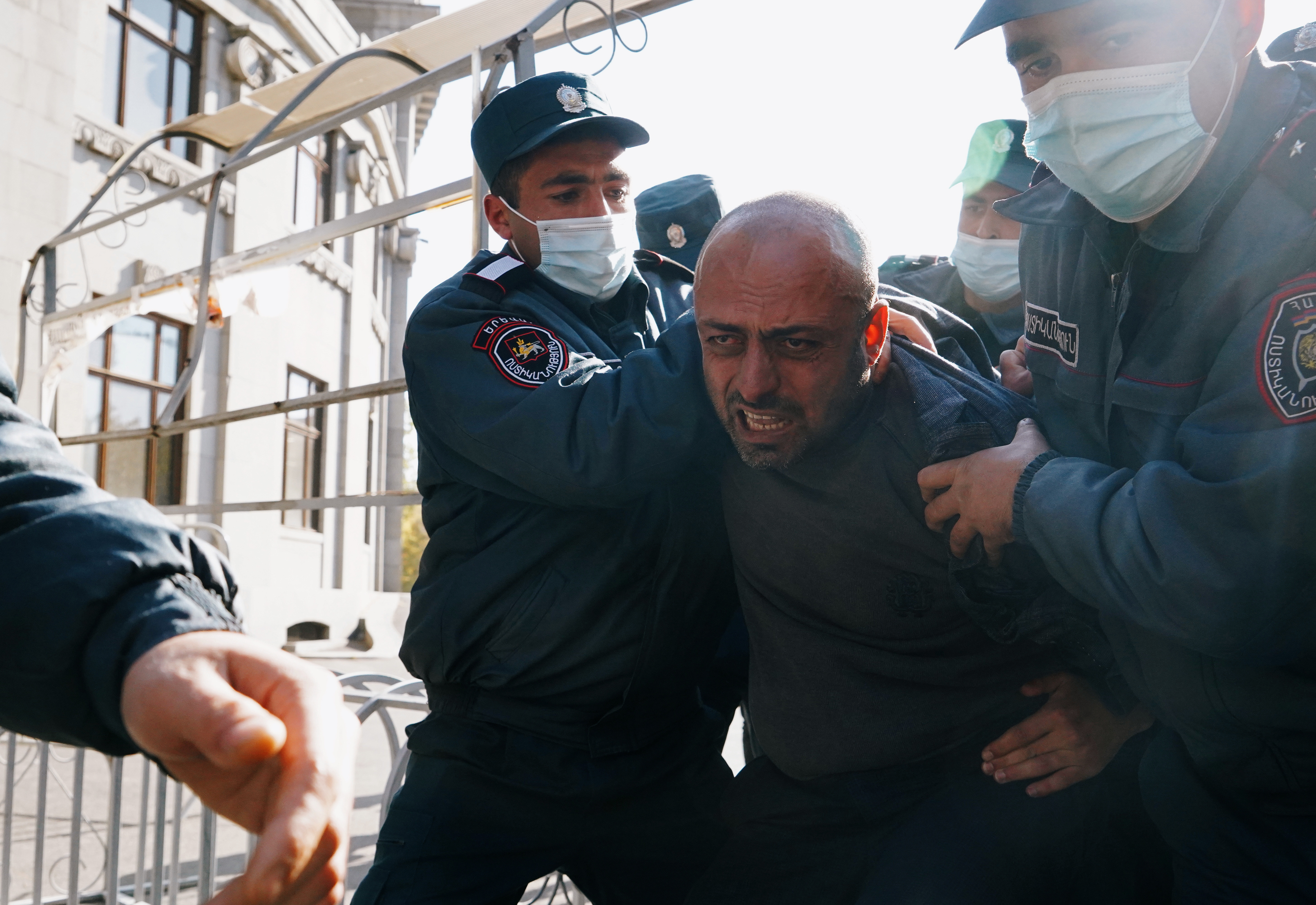 A man is taken away by law enforcement officers during an opposition rally to demand the resignation of Armenian Prime Minister Nikol Pashinyan following the signing of a deal to end the military conflict over the Nagorno-Karabakh region, in Yerevan, Armenia November 11, 2020. REUTERS/Artem Mikryukov