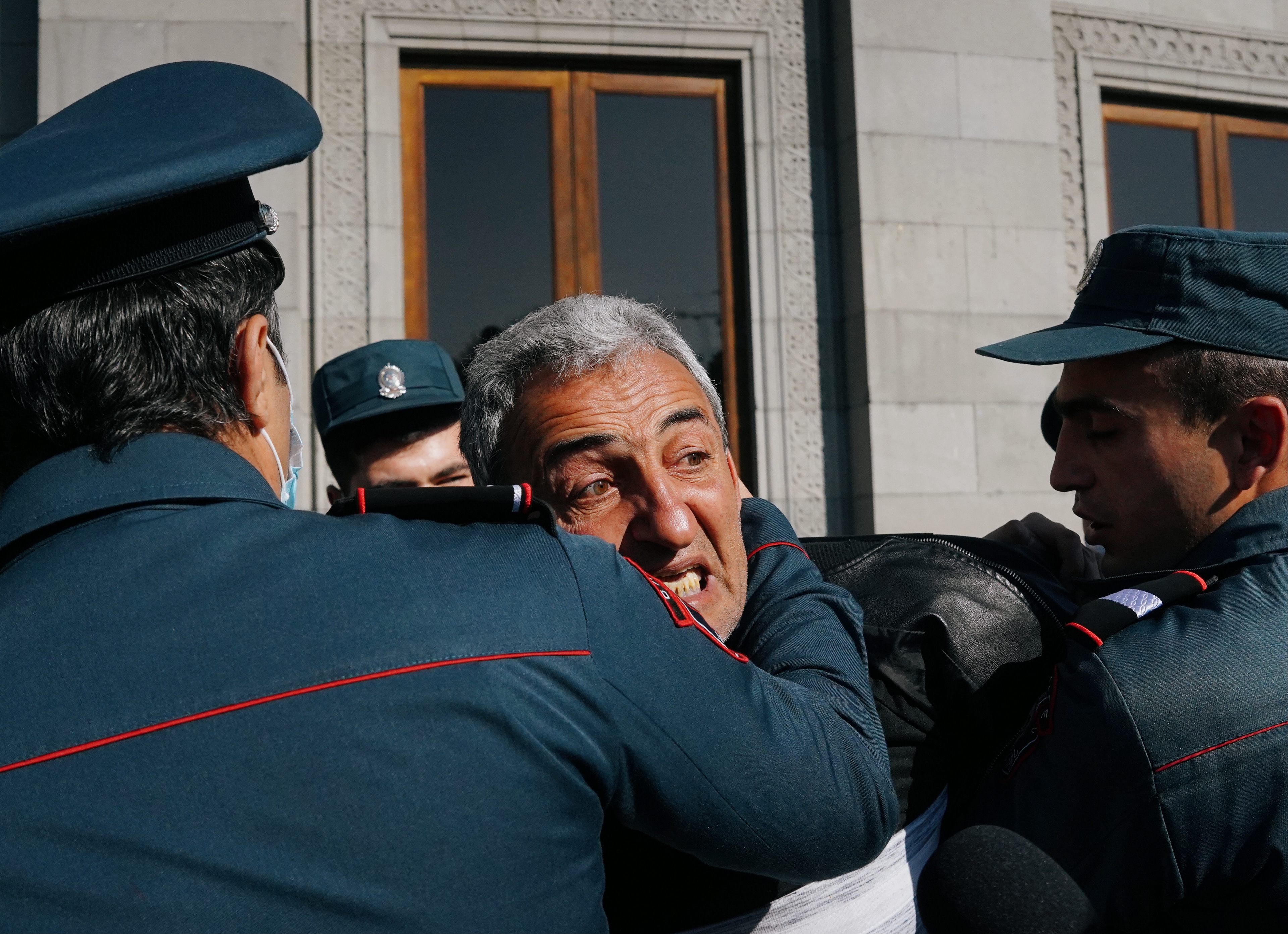 A demonstrator is taken away by law enforcement officers during an opposition rally to demand the resignation of Armenian Prime Minister Nikol Pashinyan following the signing of a deal to end the military conflict over the Nagorno-Karabakh region, in Yerevan, Armenia November 11, 2020. REUTERS/Artem Mikryukov