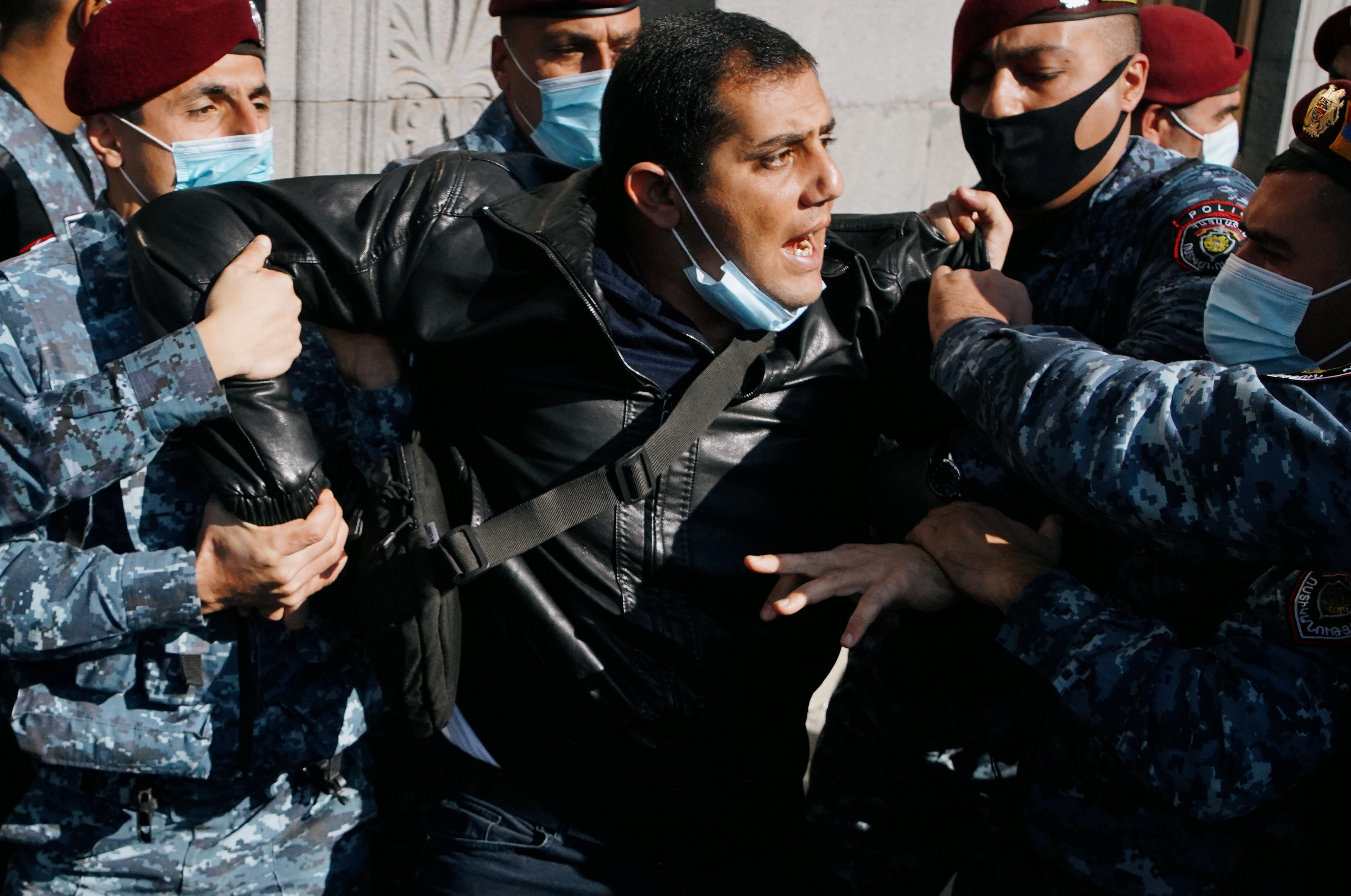 A demonstrator is taken away by law enforcement officers during an opposition rally to demand the resignation of Armenian Prime Minister Nikol Pashinyan following the signing of a deal to end the military conflict over the Nagorno-Karabakh region, in Yerevan, Armenia November 11, 2020. REUTERS/Artem Mikryukov
