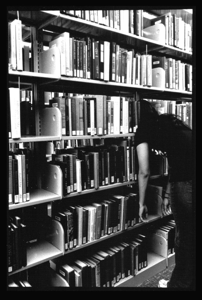 A self portrait from my first assignment in Photography 101 showcasing my love for prolonged study. Shot in the Lied Library. February 2009 | Nikon FE 35 mm Film SLR , AF Nikor 24-50mm, Silver Gelatin Print