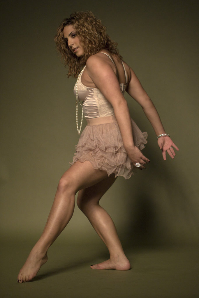 Natalie, a volunteer model, creates excellent line in this studio shot from Commercial Photography using and large silver parabolic umbrella and the modeling light. December 2011 | Canon Rebel T1i, Kit Lens